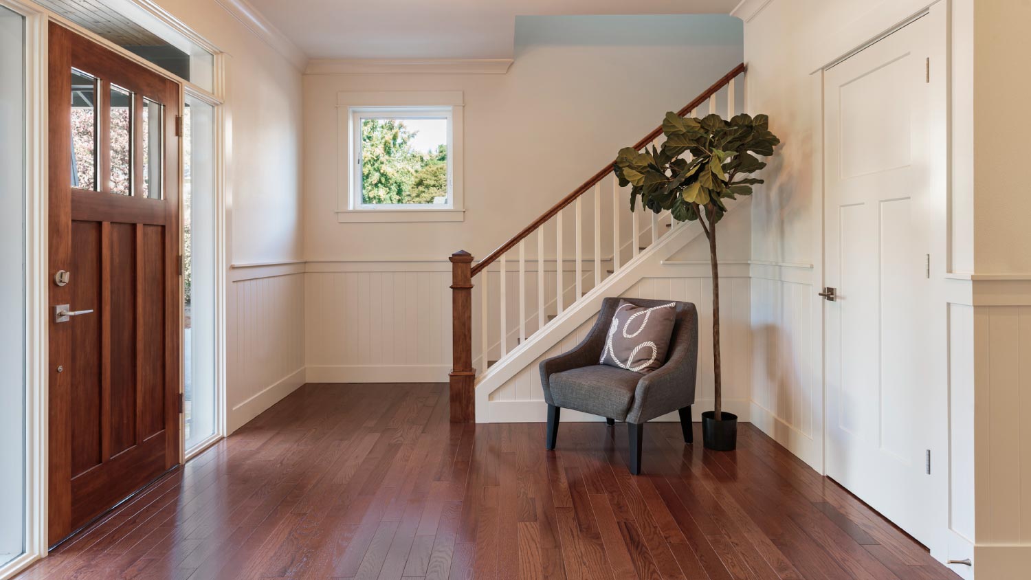 Armchair and tree in house entryway