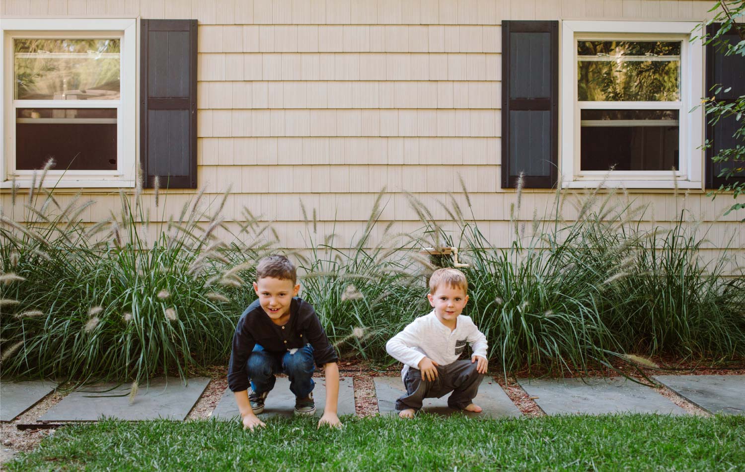 Two boys playing in the stone walkway