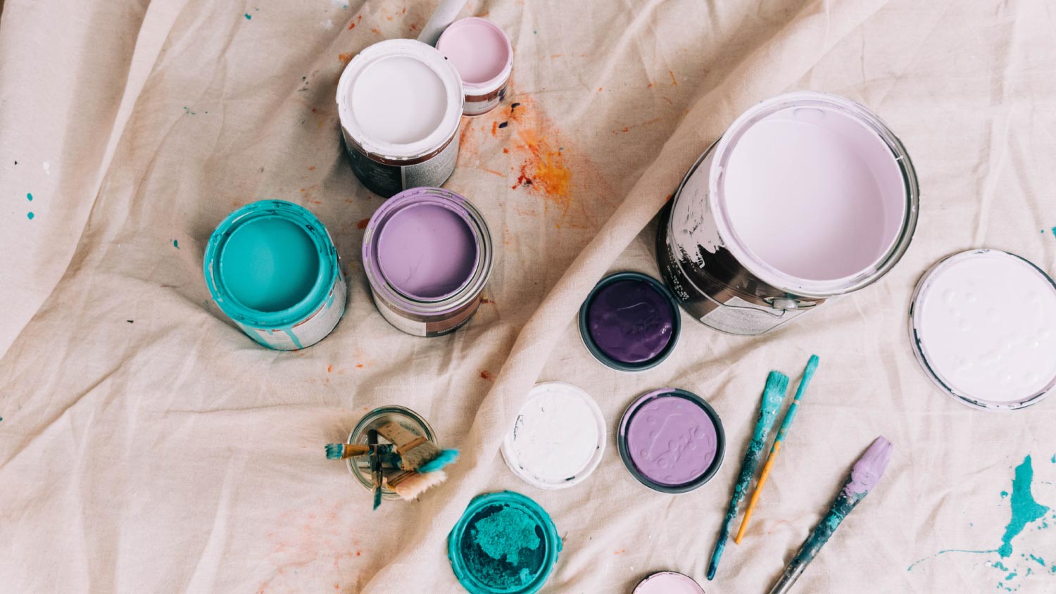 Cans of colorful paint from a high up angle