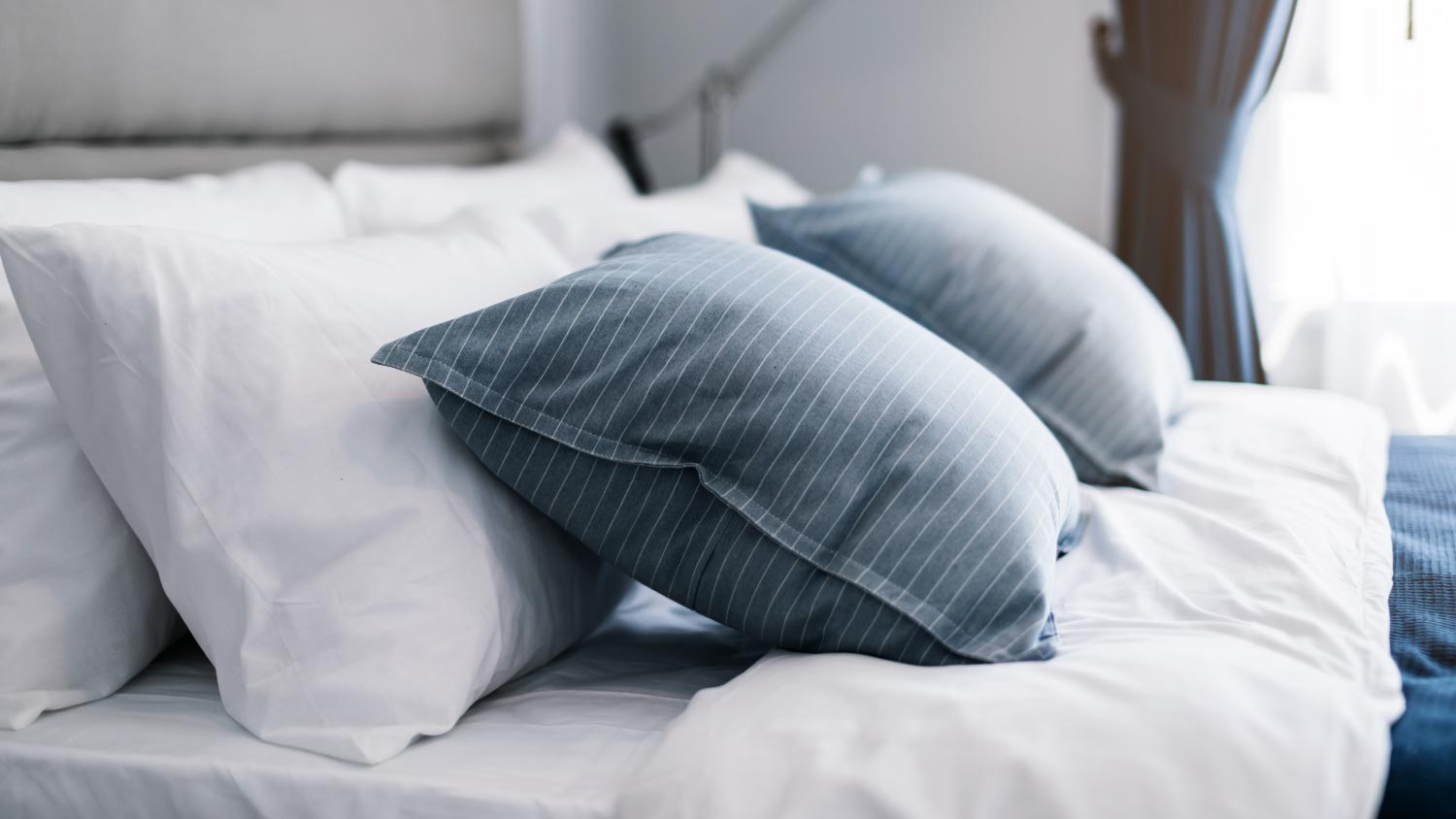 Clean white pillows and bed sheets