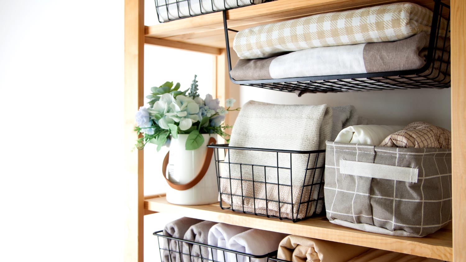 Closet with bed sheets and towels