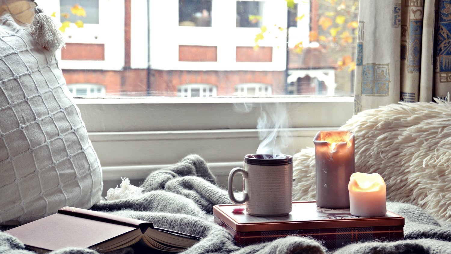 cup of coffee sitting on living room table by sofa