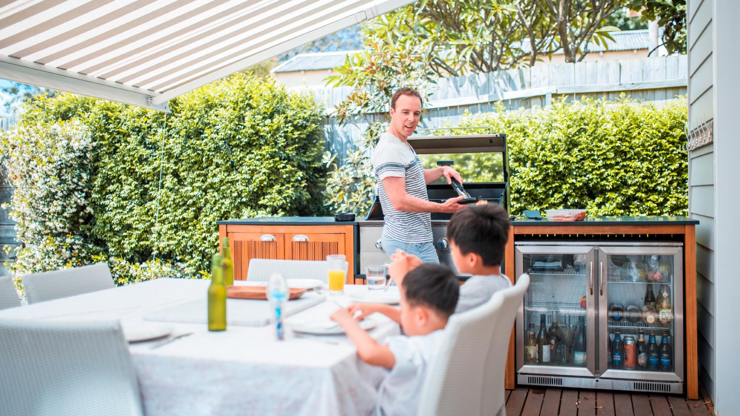 A family with two children having lunch outdoors