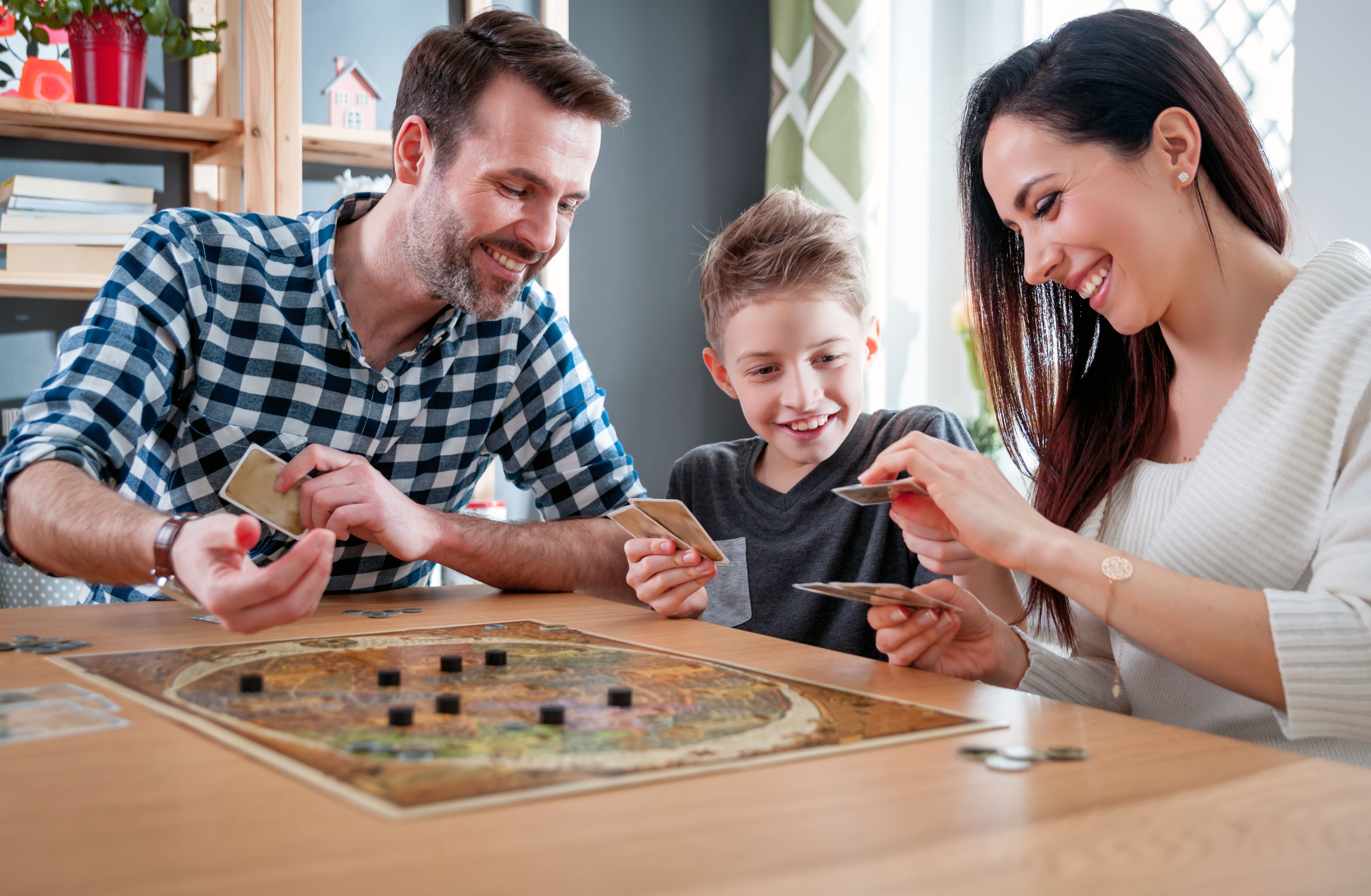 Family playing board game at table