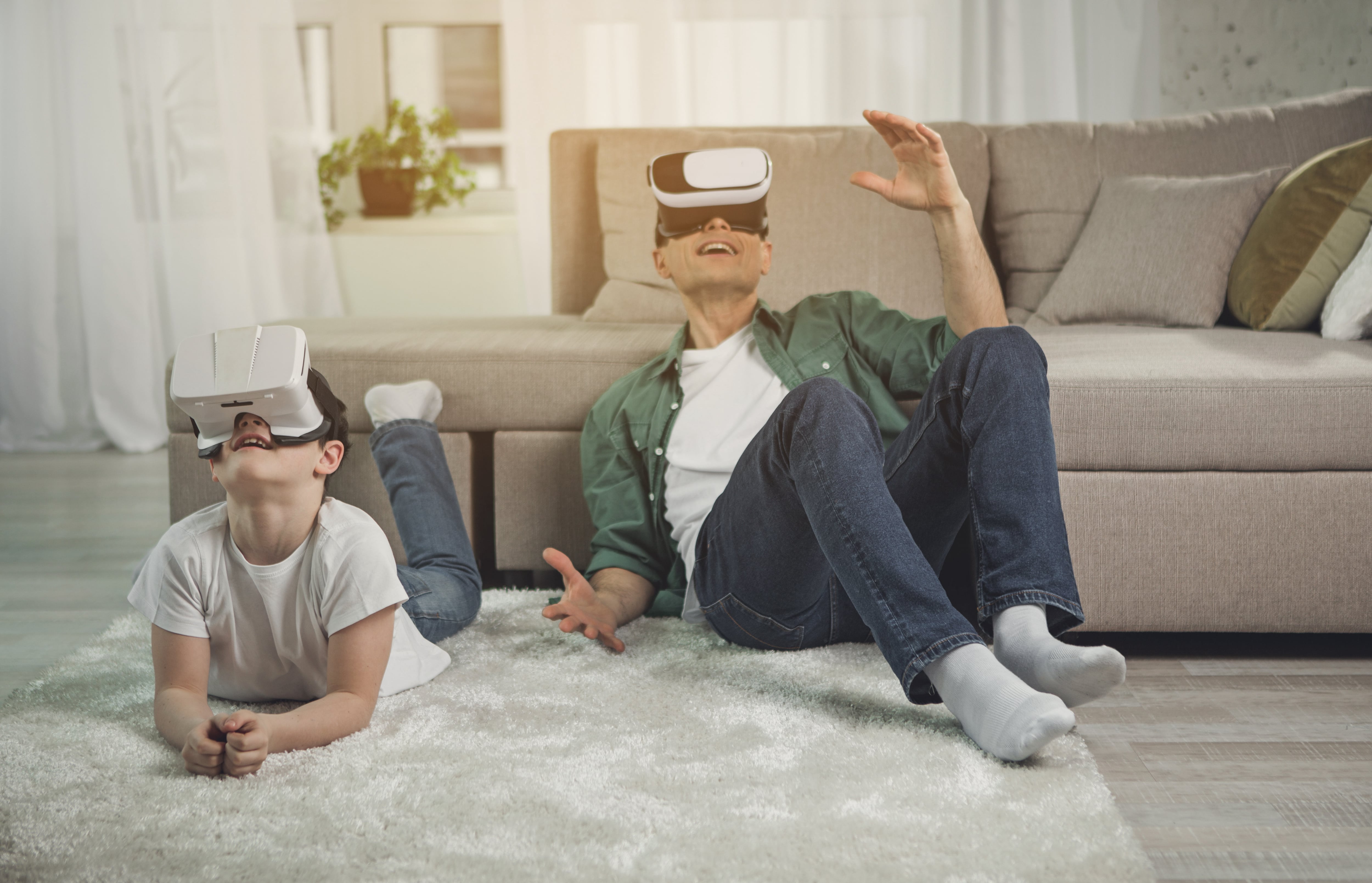Father and son playing with virtual reality goggles
