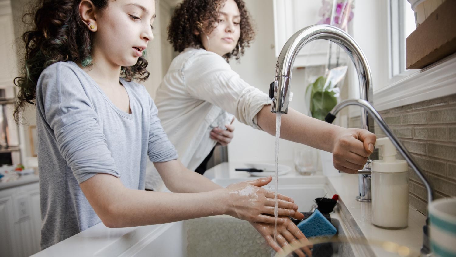 Girls washing hands with soap