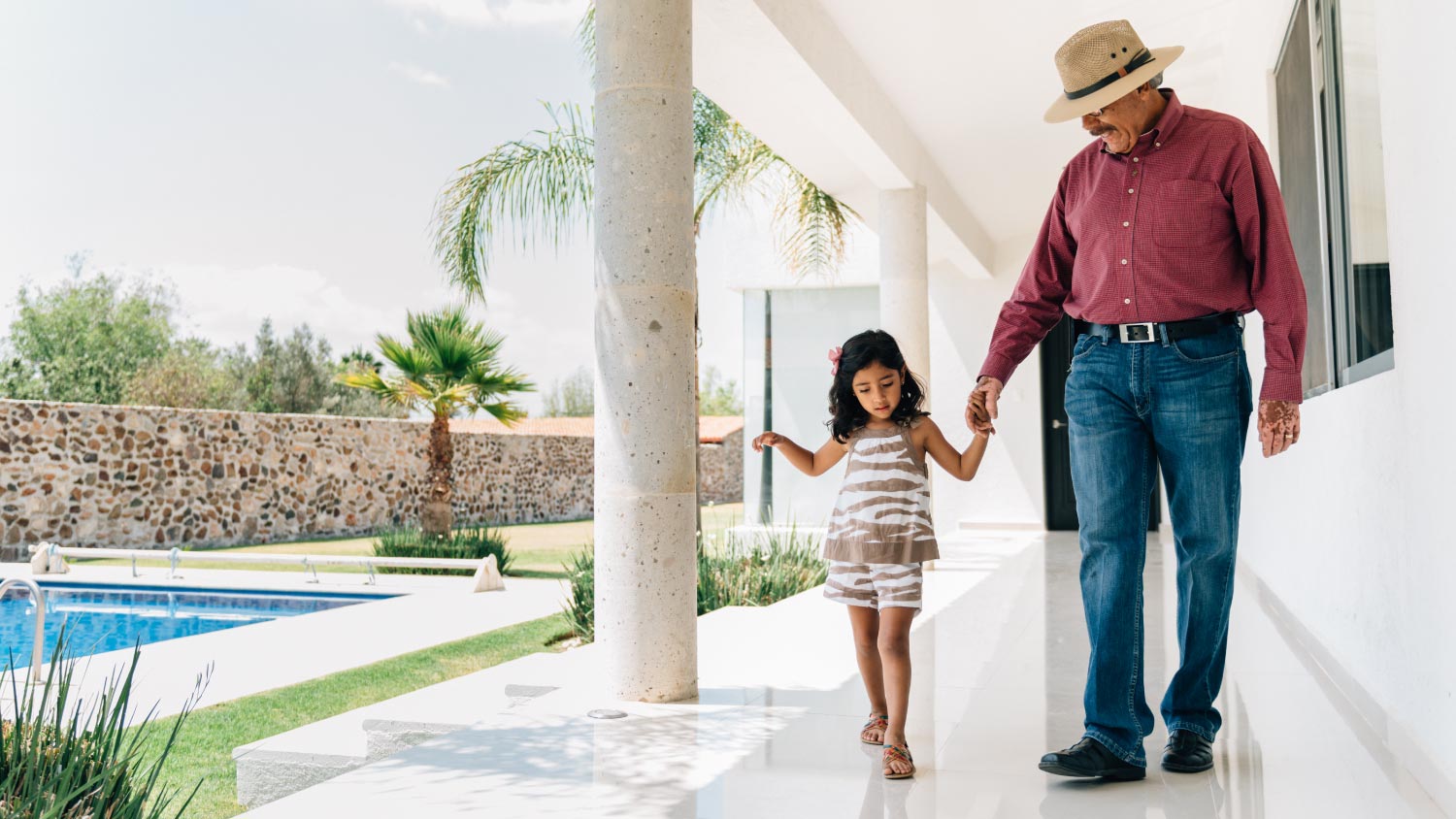 Grandfather and granddaughter walking