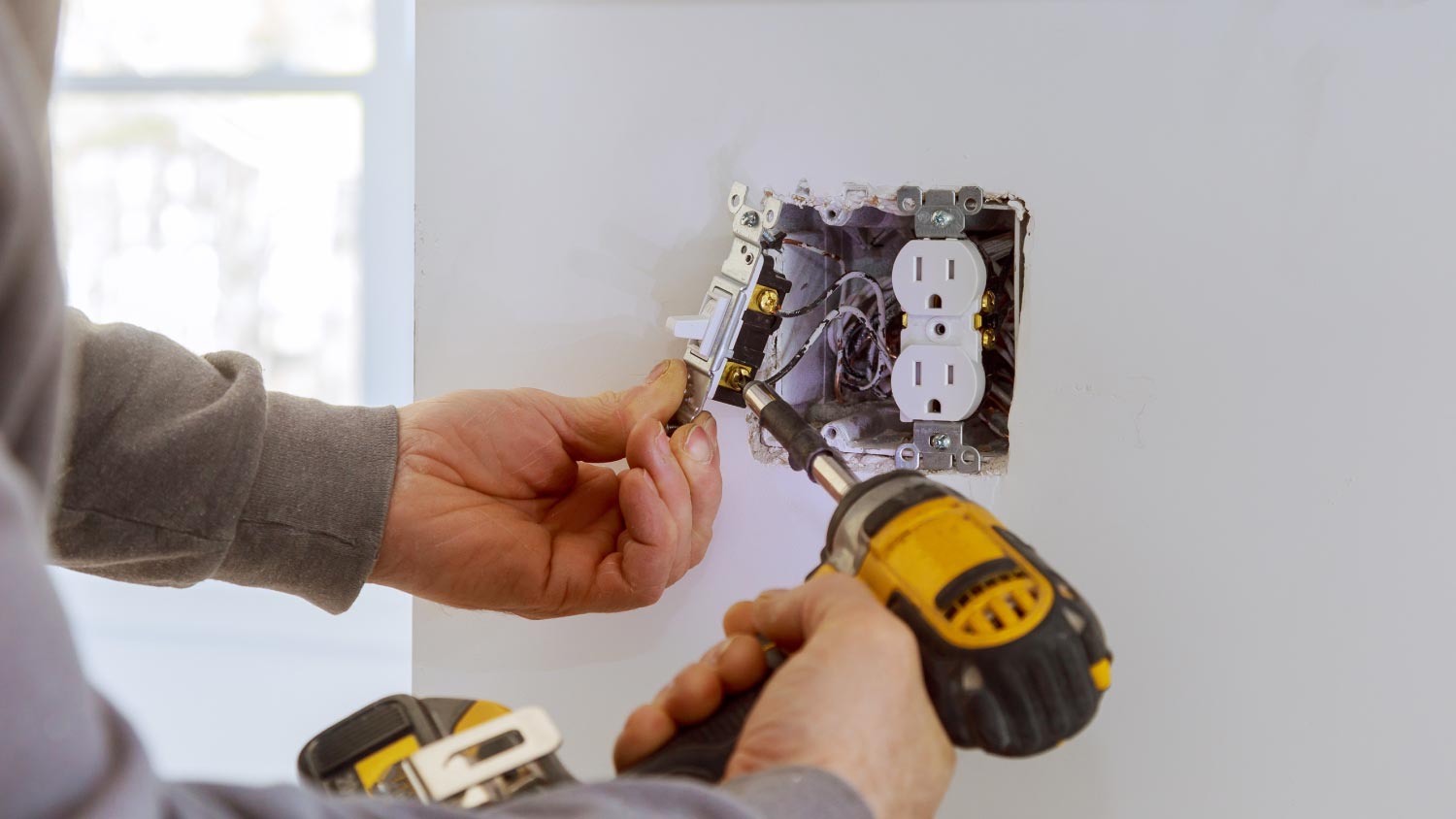 Man installing electrical outlets