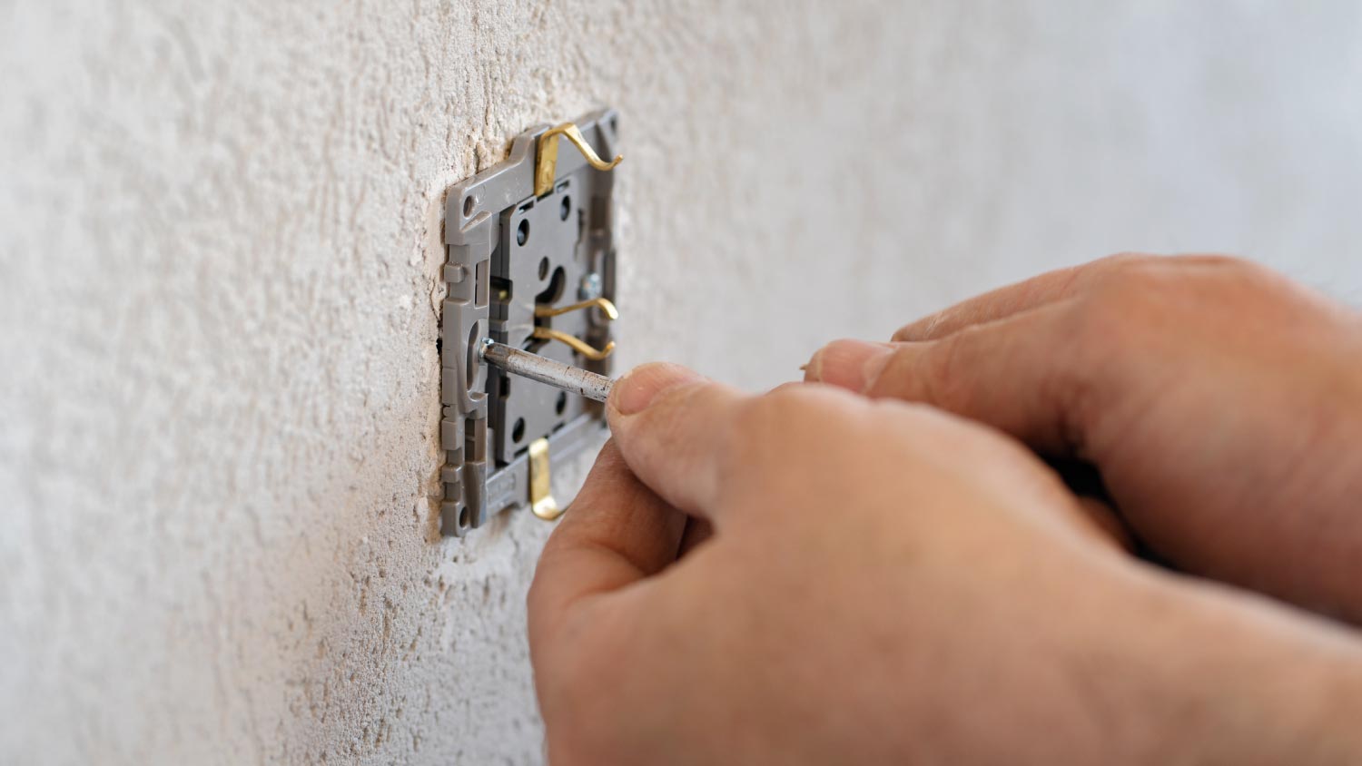 Man working on the plug electrical outlet