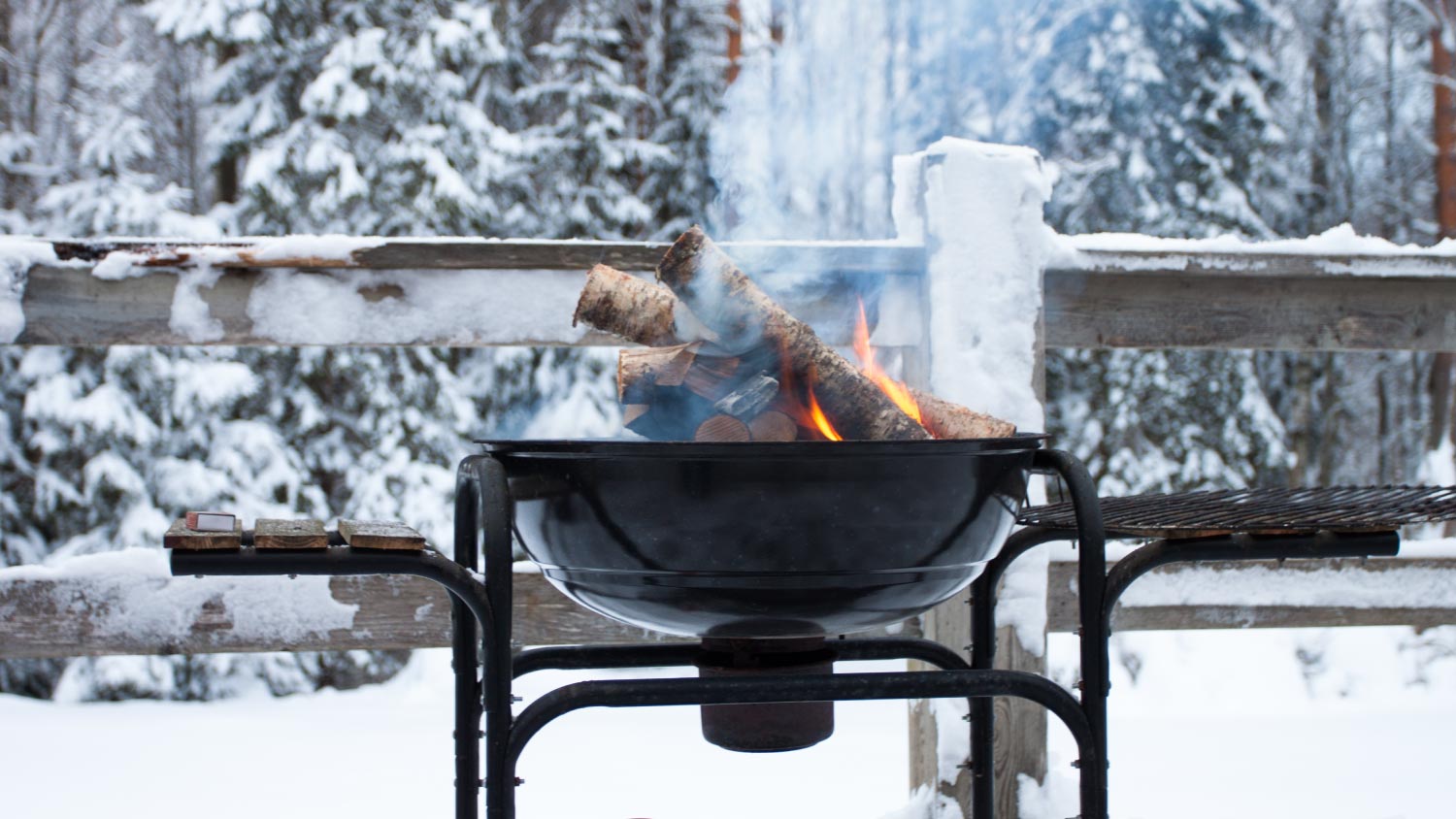  A metal grill with a glowing wood