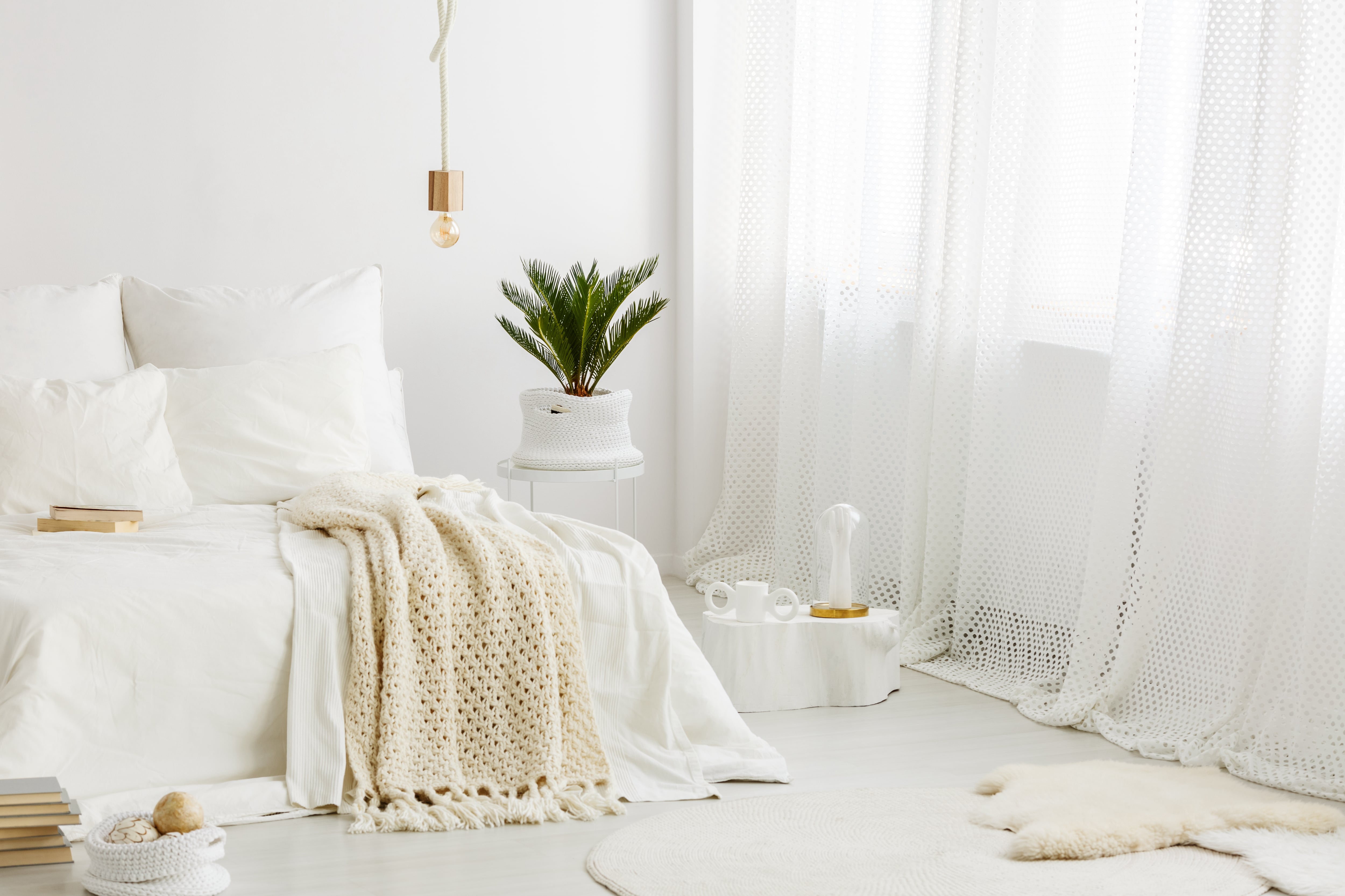 White and airy bedroom with some cream-colored accents