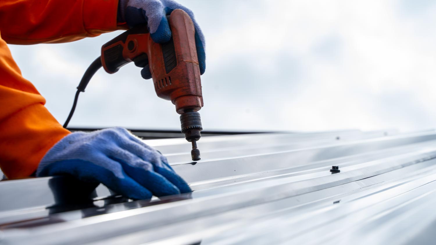 Roofer worker using air or pneumatic nail gun