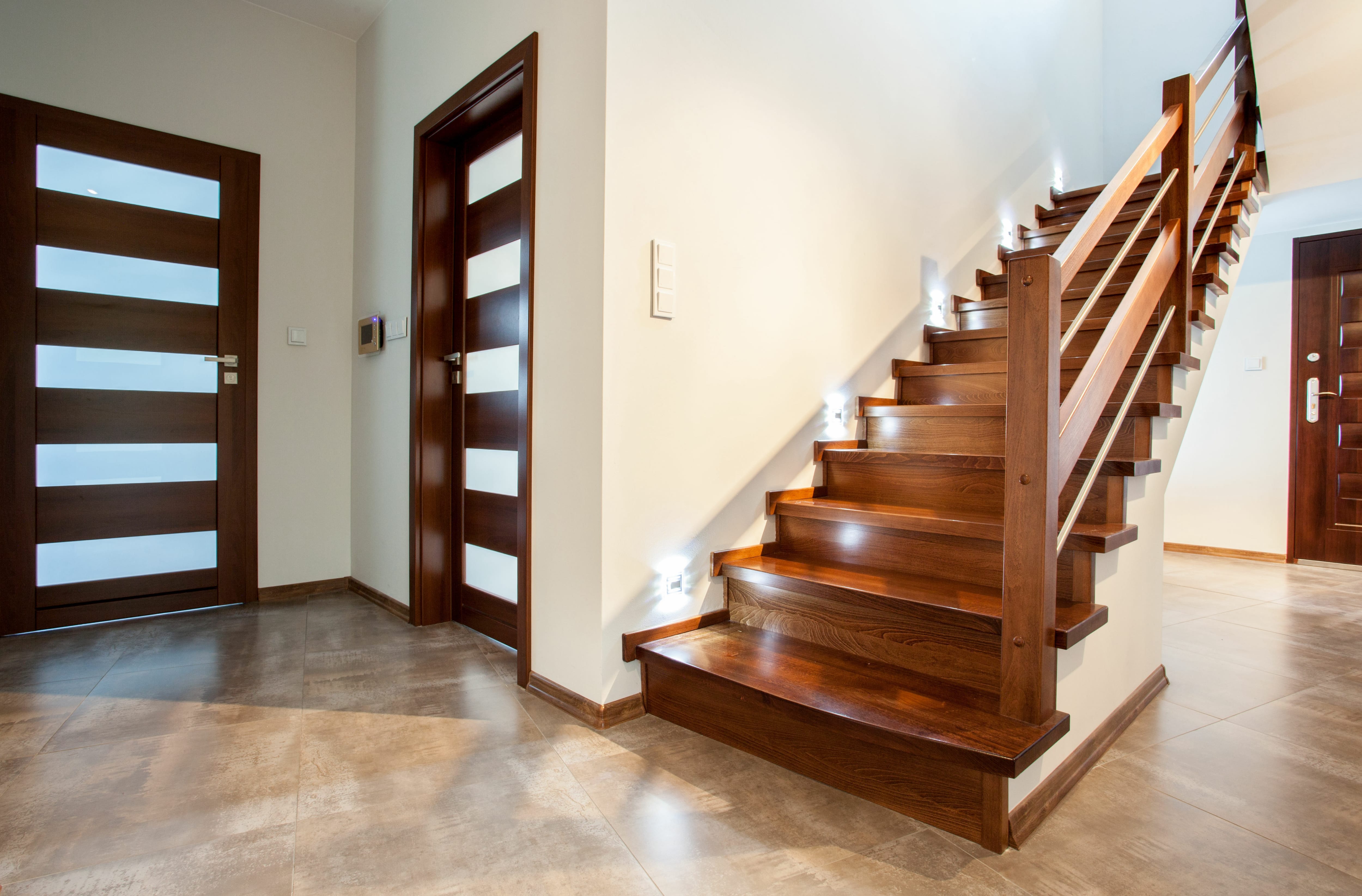 A modern wooden staircase with built-in lighting