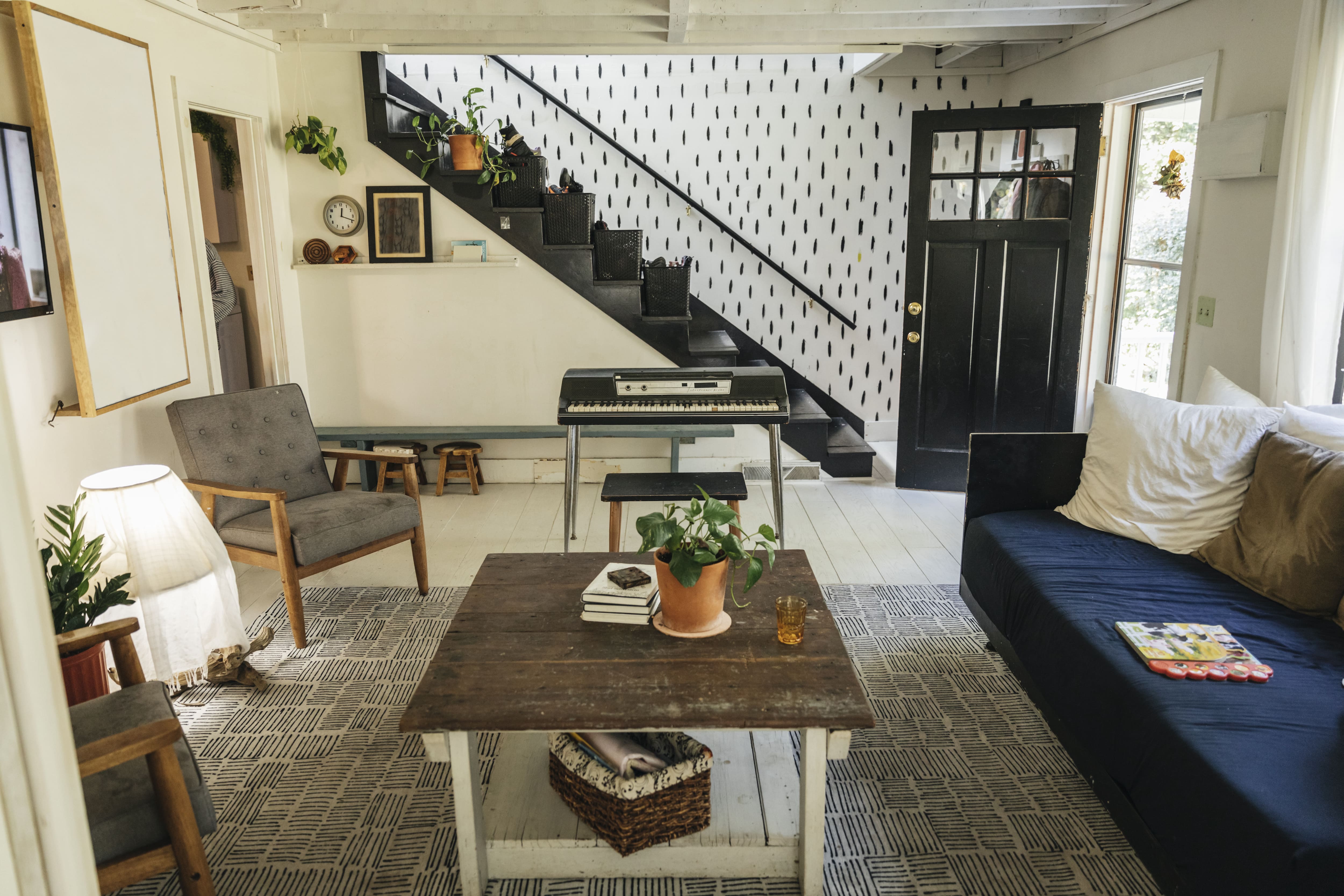 An interior staircase wall covered in black line painted patterns 