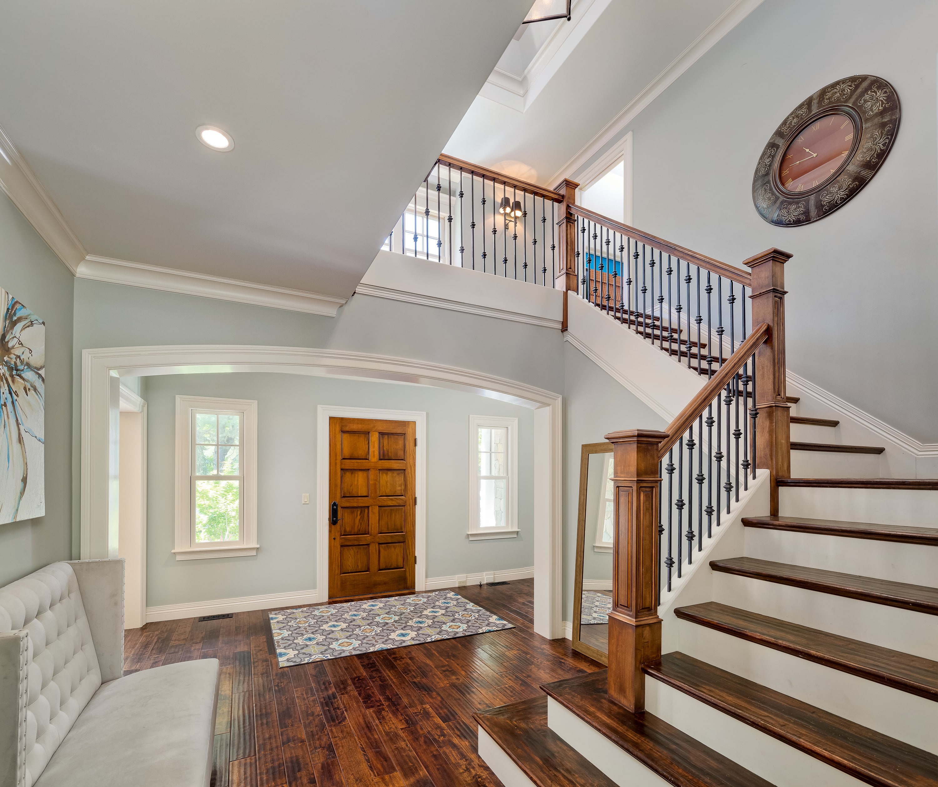 Interior staircase decorated with a large round clock