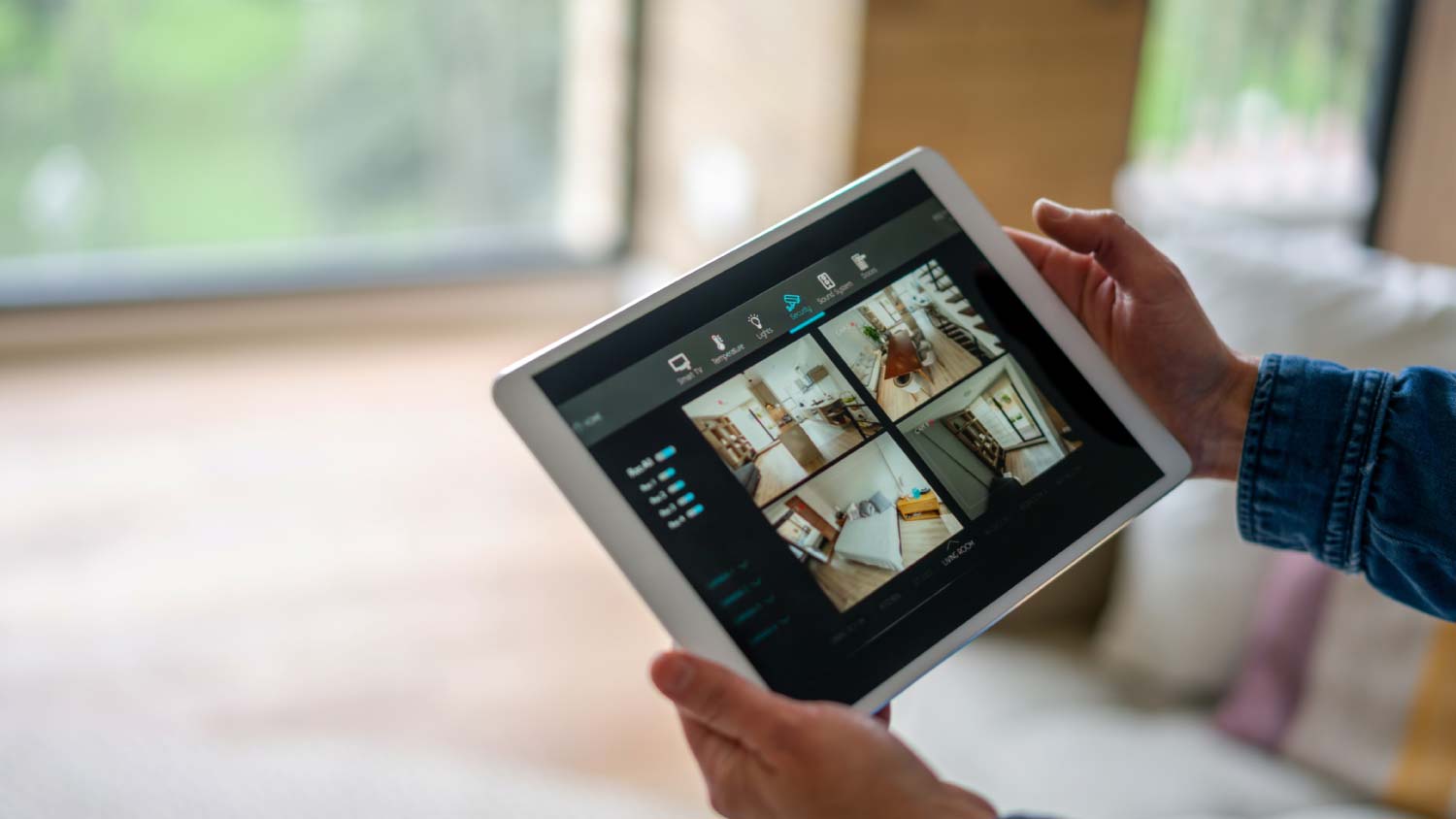 A woman monitoring her house with a home security system