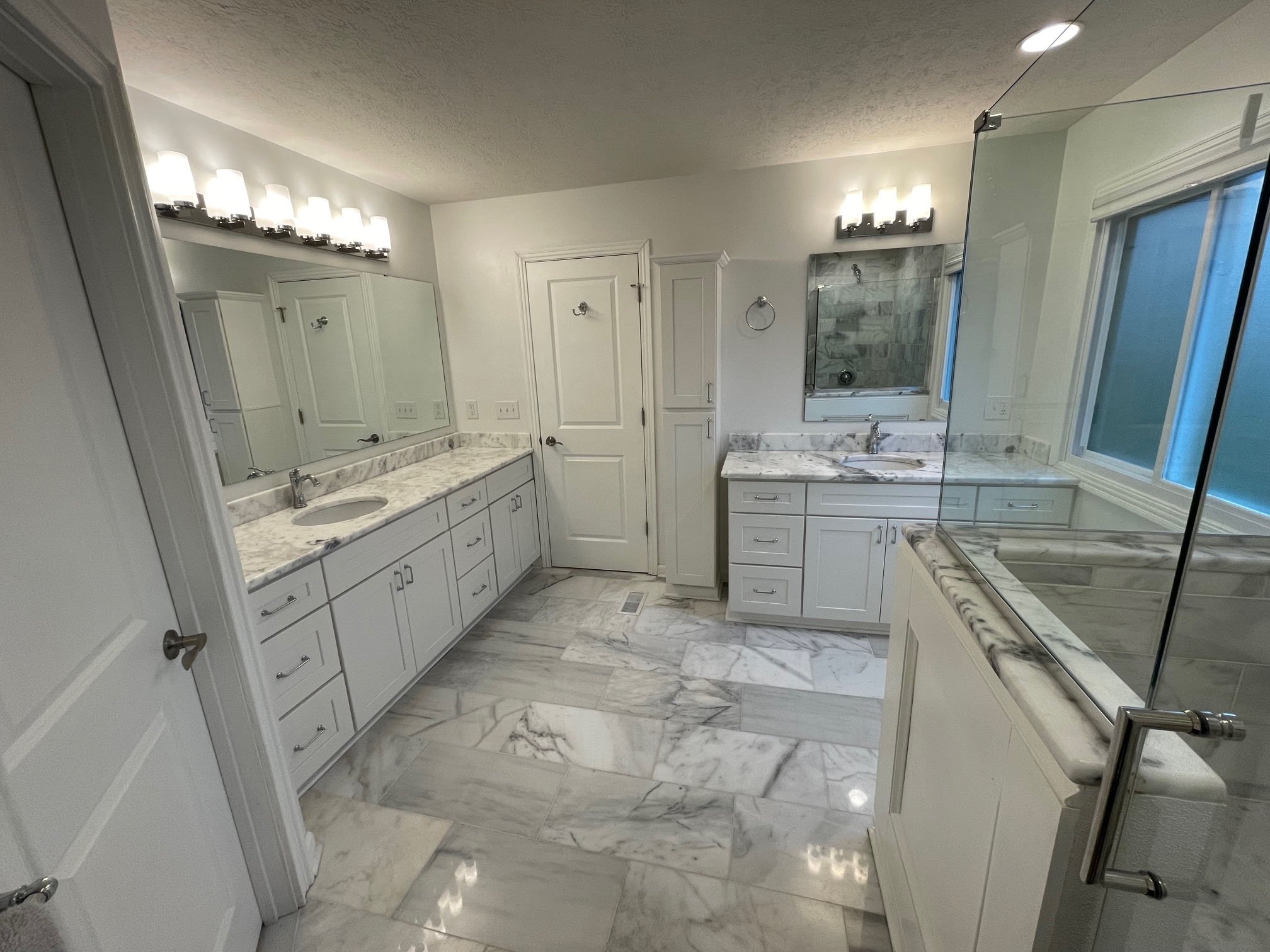 White bathroom with marble tile floors