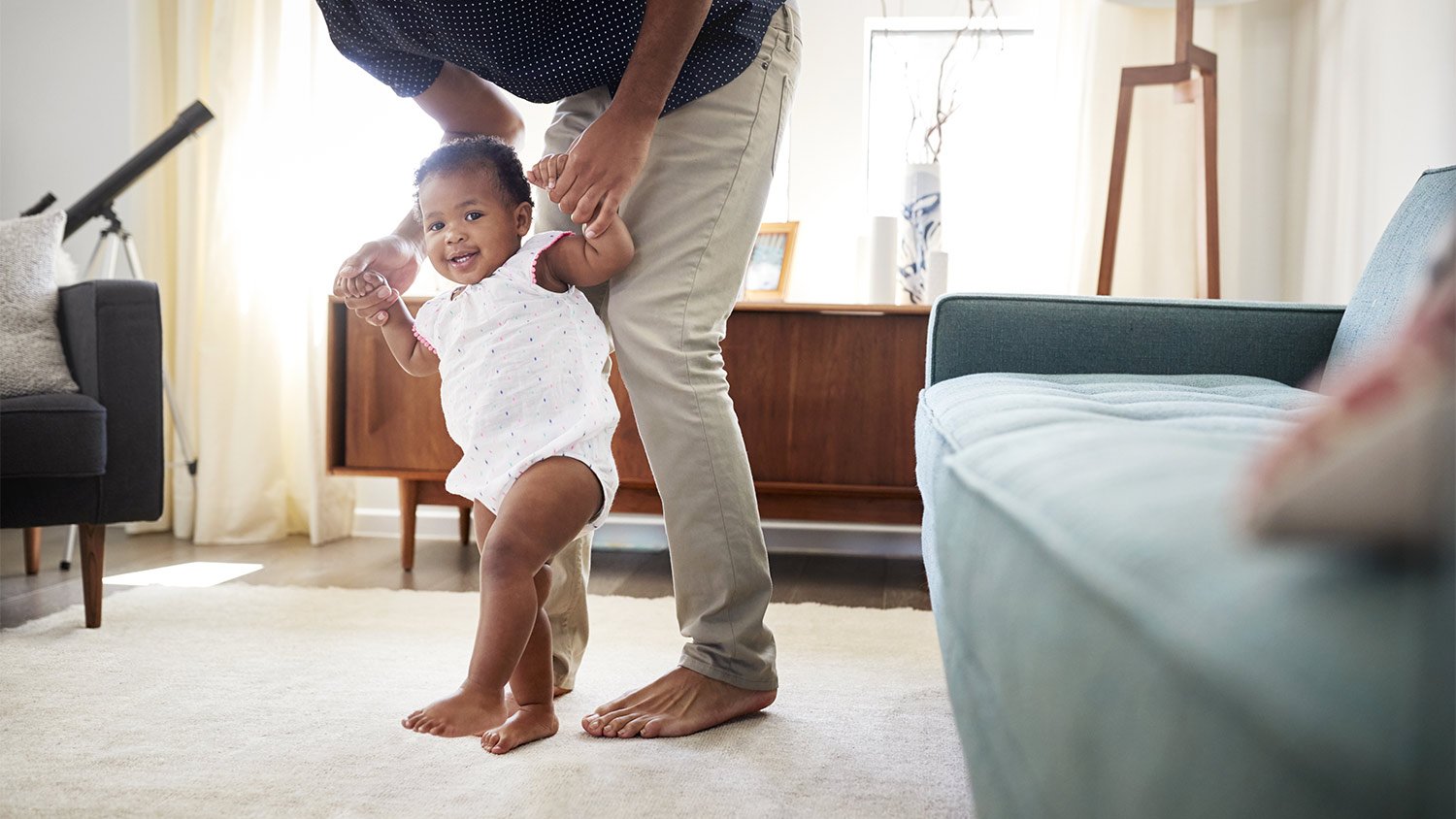 Baby walking steps dad living room