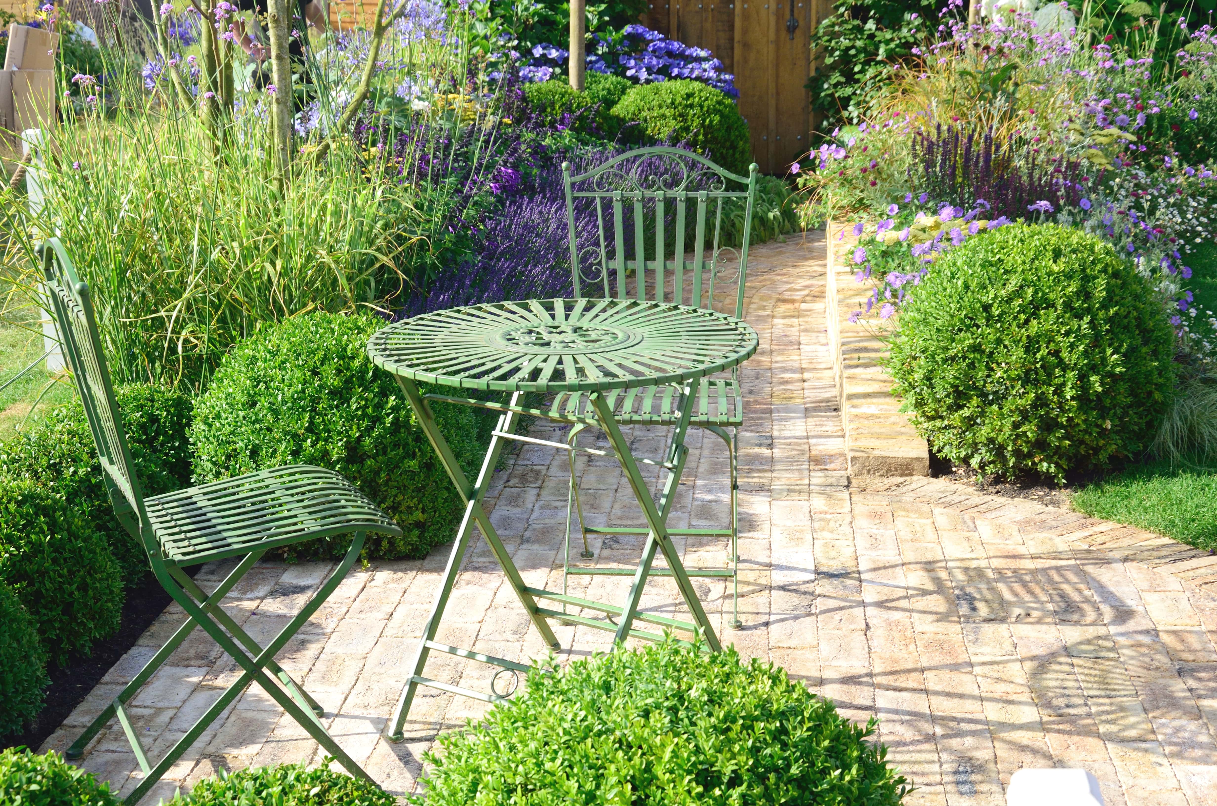 Wrought iron bistro set in backyard garden