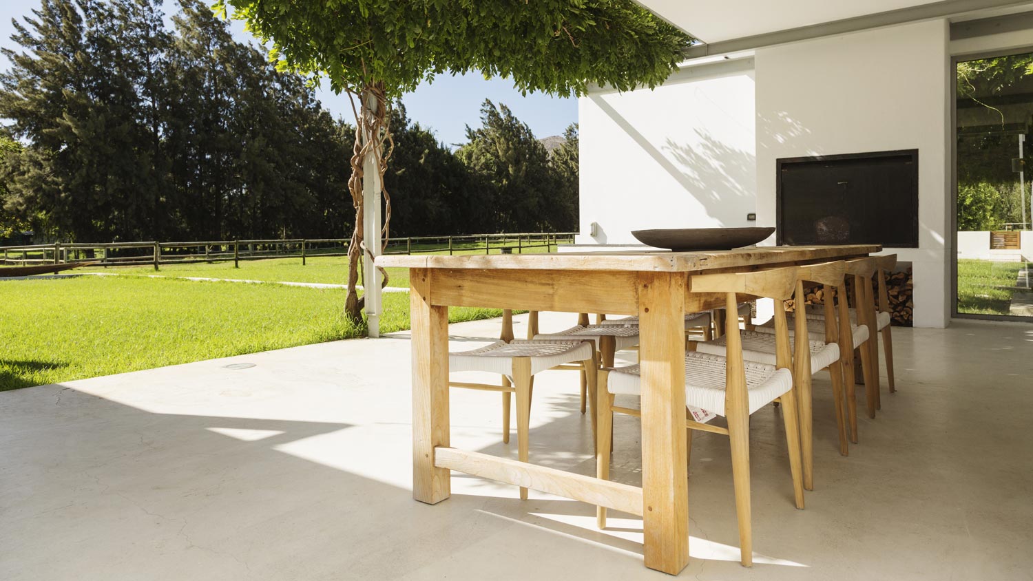 A backyard with a dining area and a tv