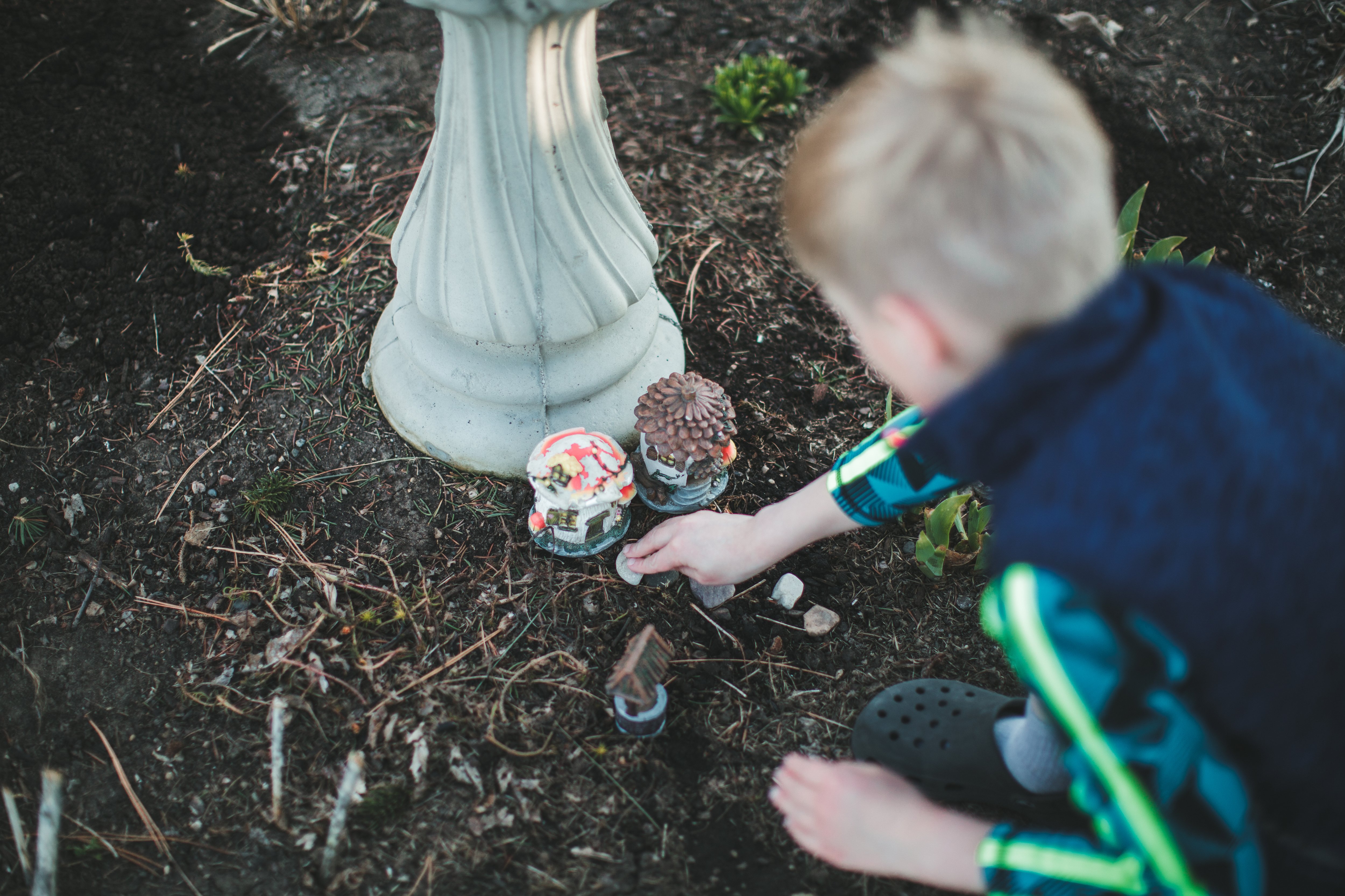 Boy setting up a fairy garden