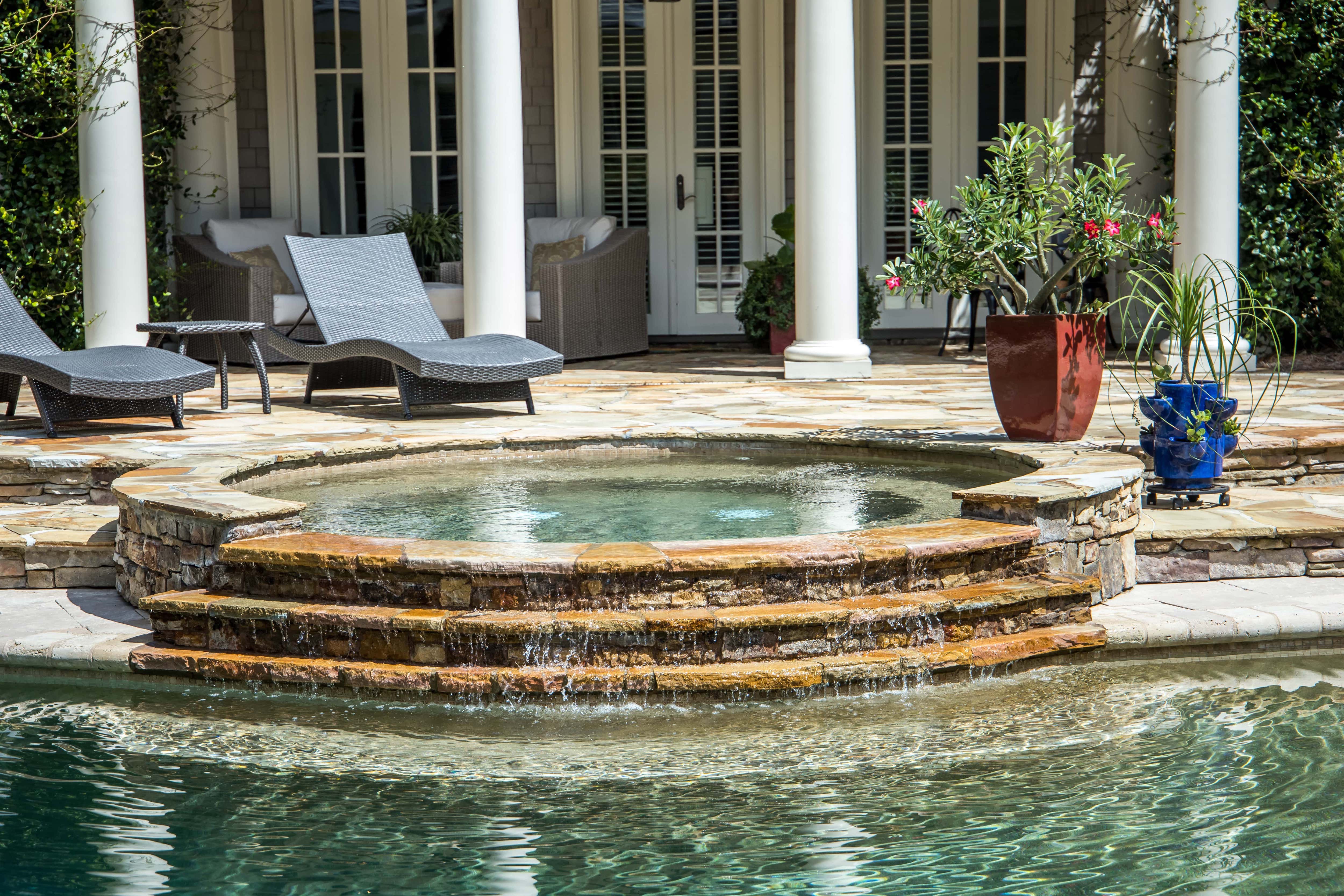 Pool and hot tub in the backyard of a house