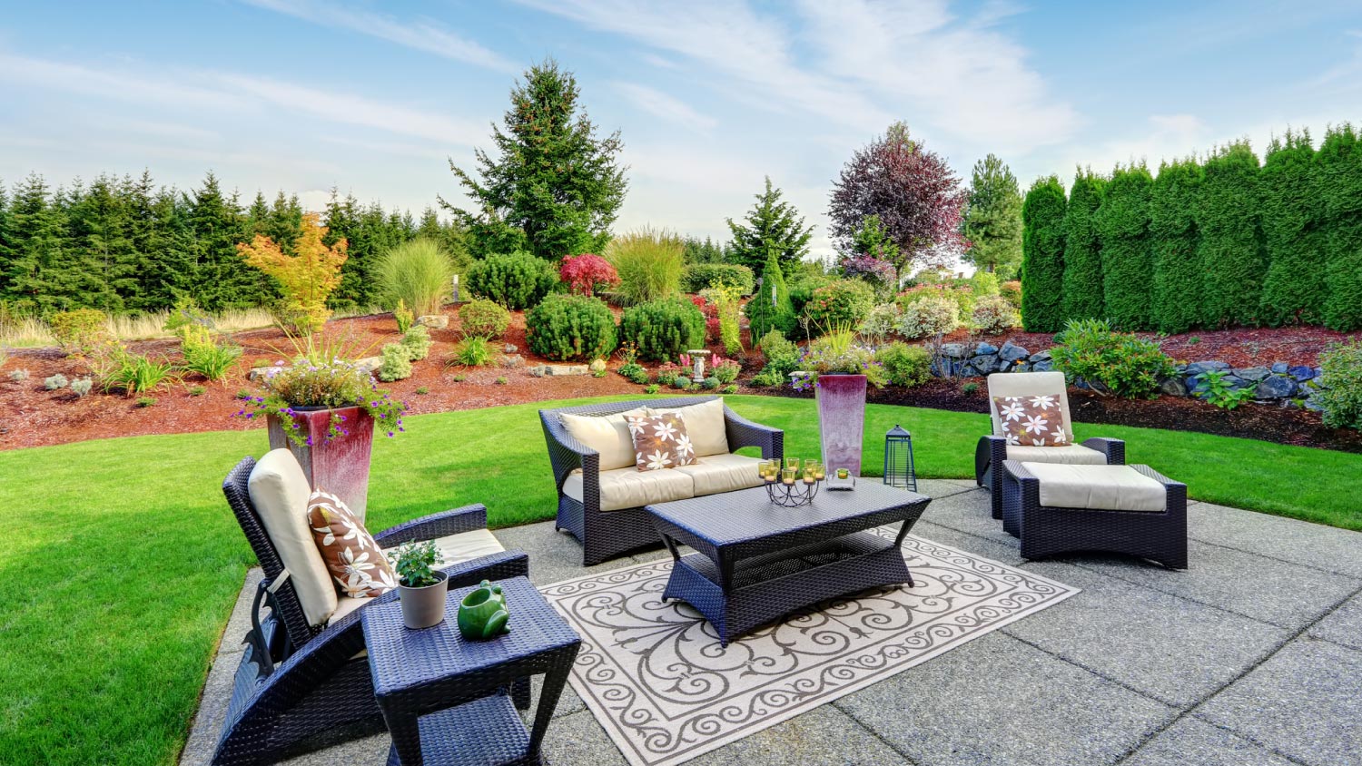 Impressive backyard landscape design with patio area