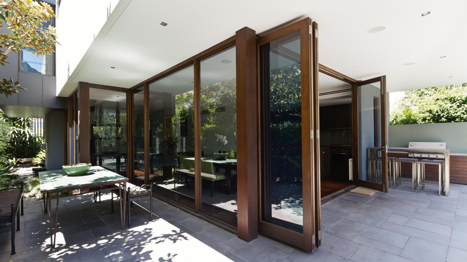A backyard with open bifold doors