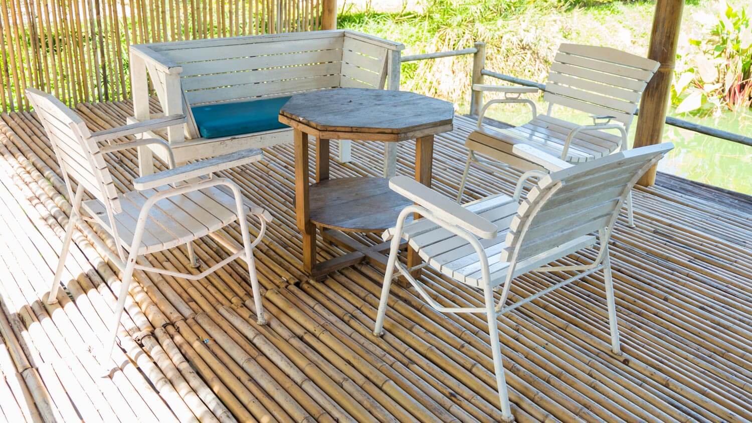 A bamboo deck with a dining table and chairs