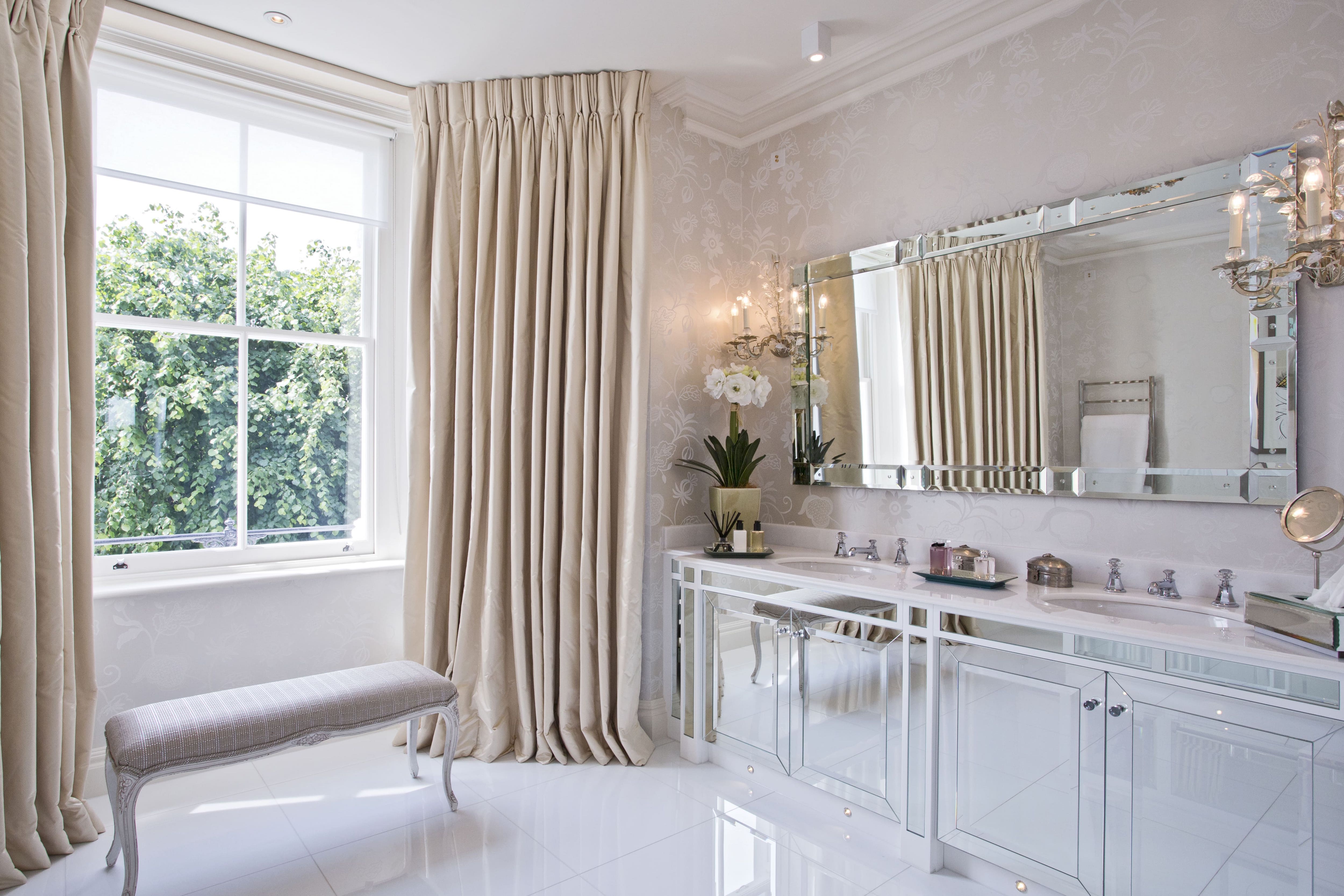 Luxury bathroom with curtains and settee bench