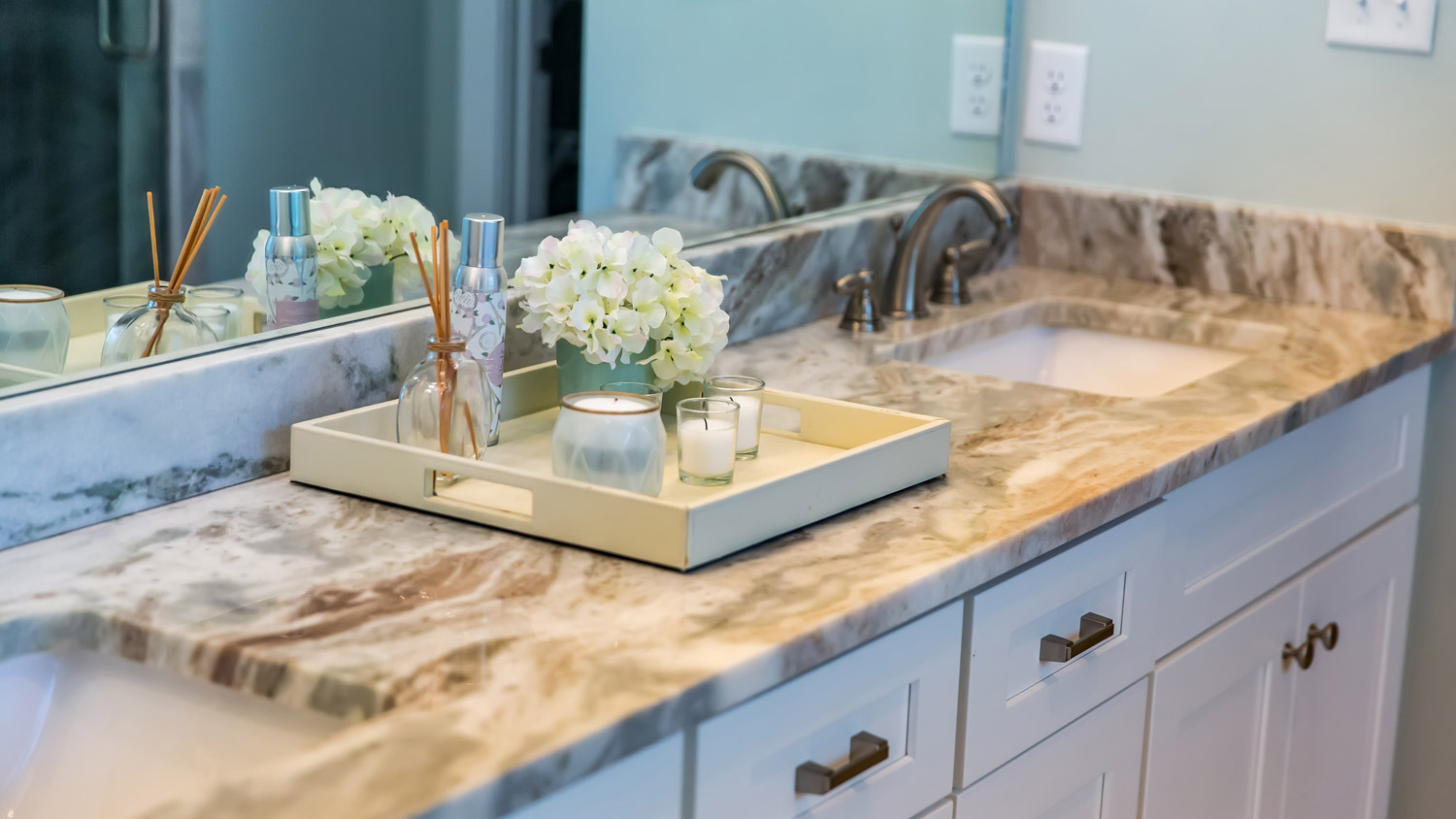 A bathroom with granite countertop and a double sink