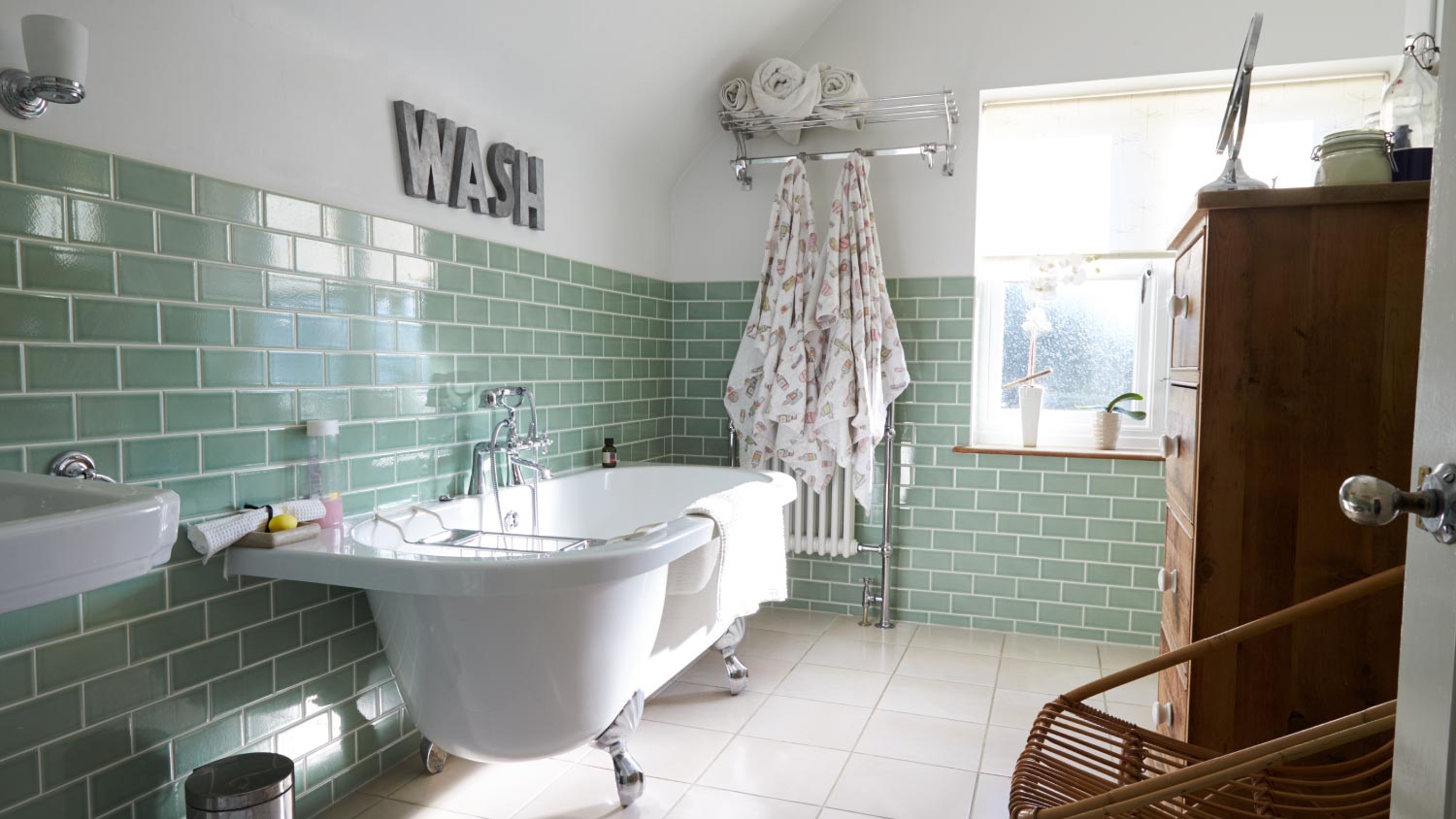 A bathroom with green tiles