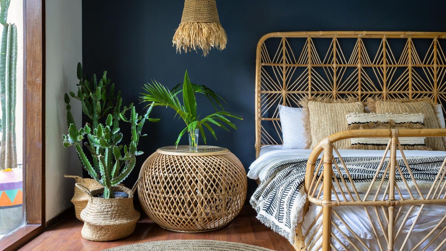 A bedroom with ethnic decor and rattan furniture