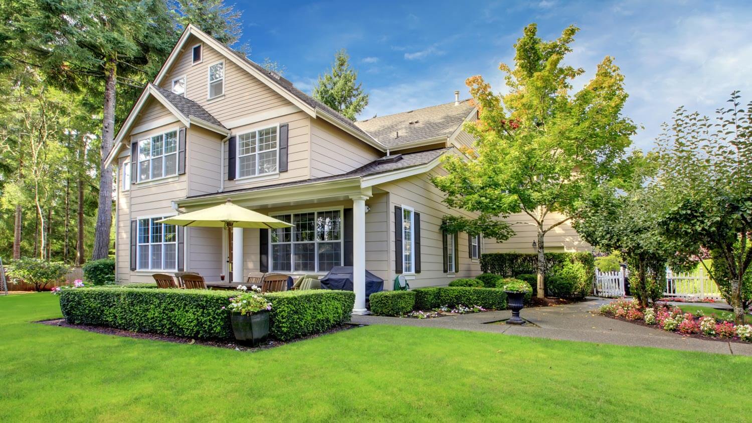 A beige painted house with a patio