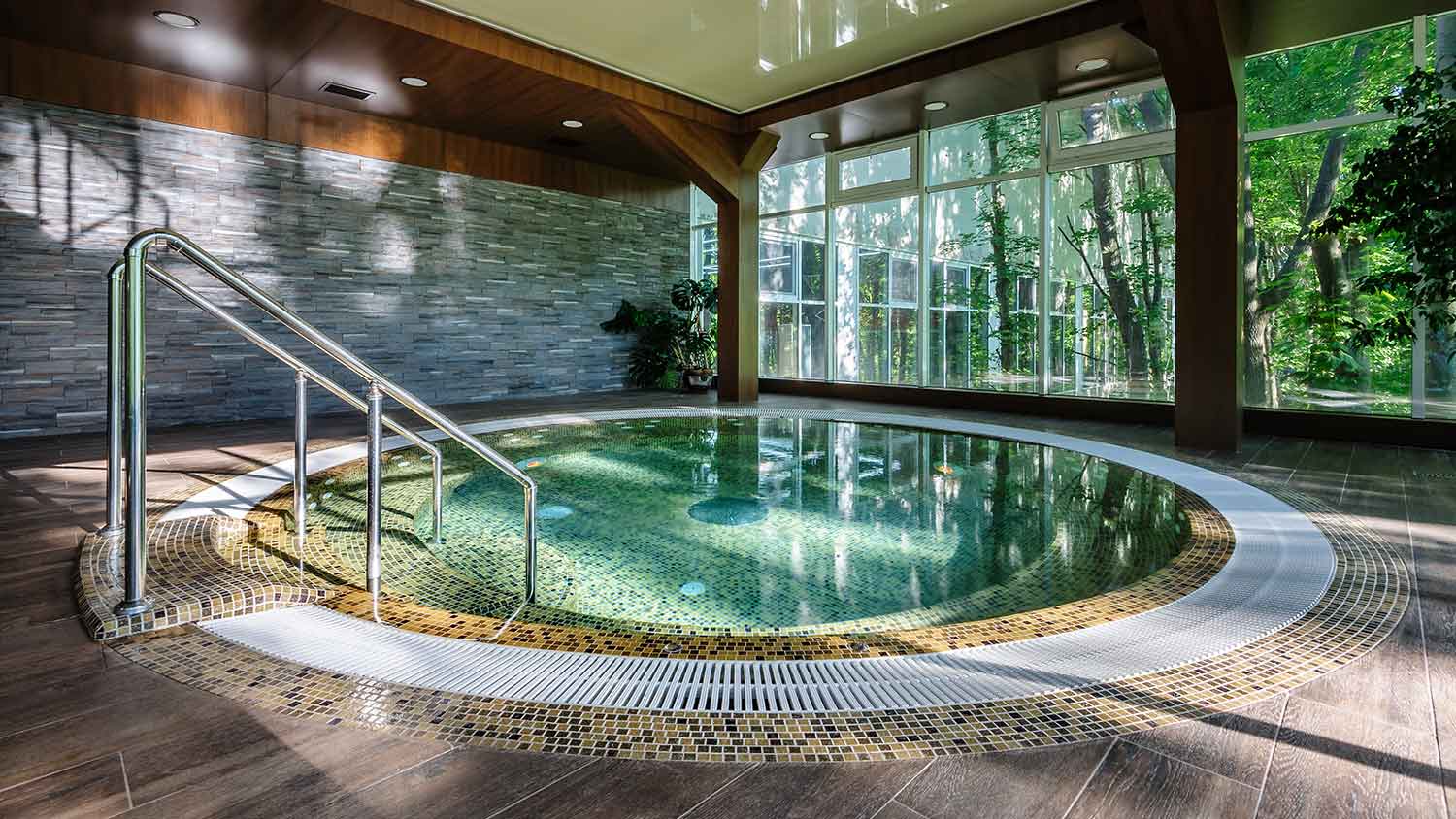 Big luxury tiled hot tub in a covered area