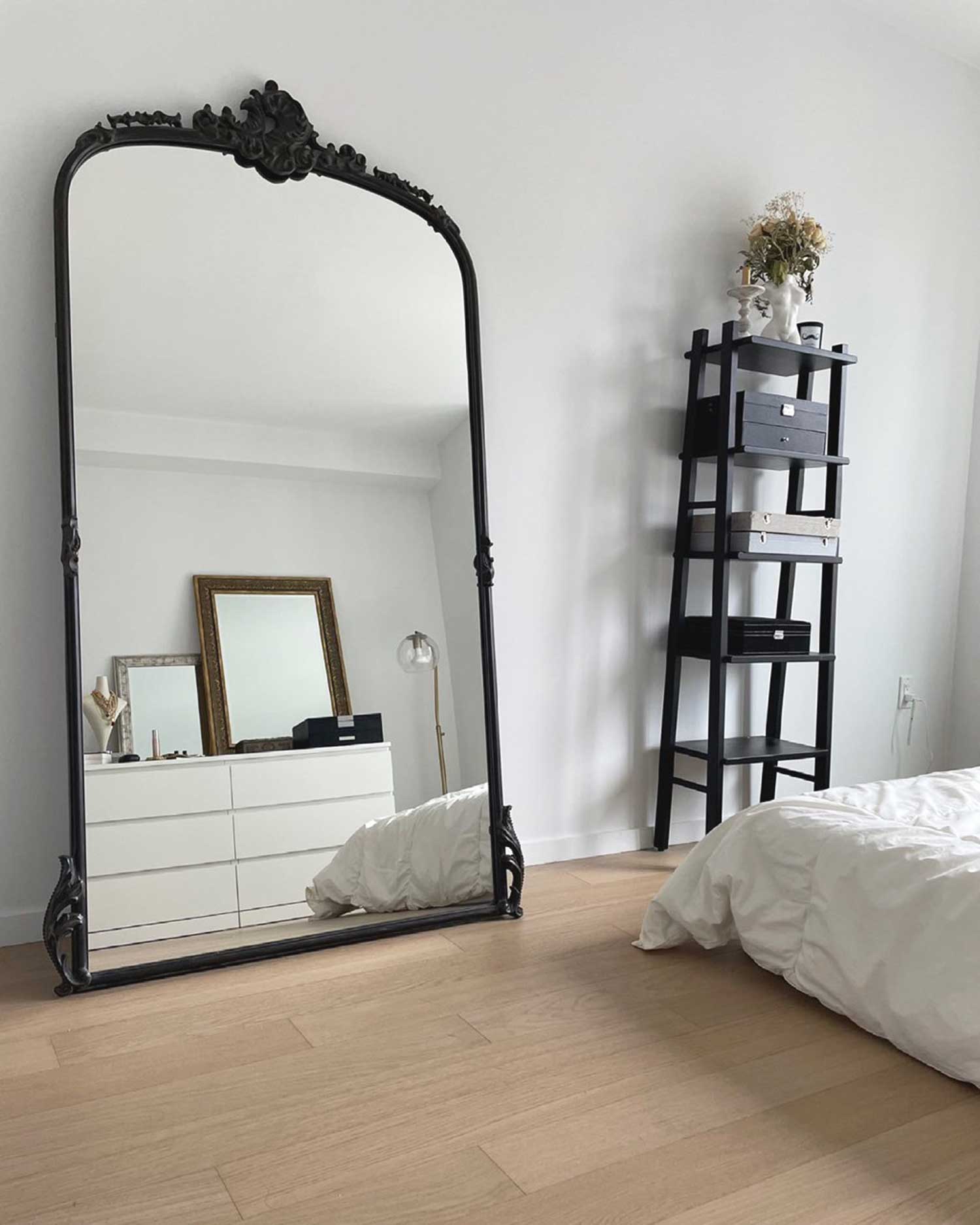 Big mirror with back frame in a bedroom