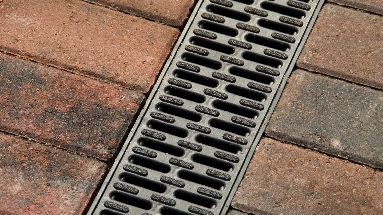 A close up of a block paving drain