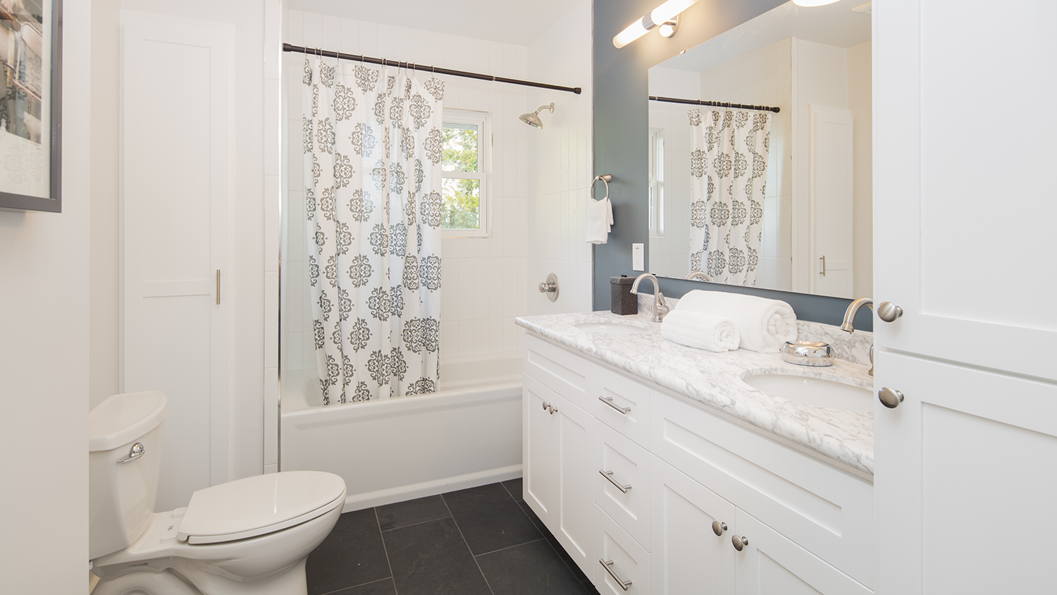 Bathroom with blue walls and white marble countertops