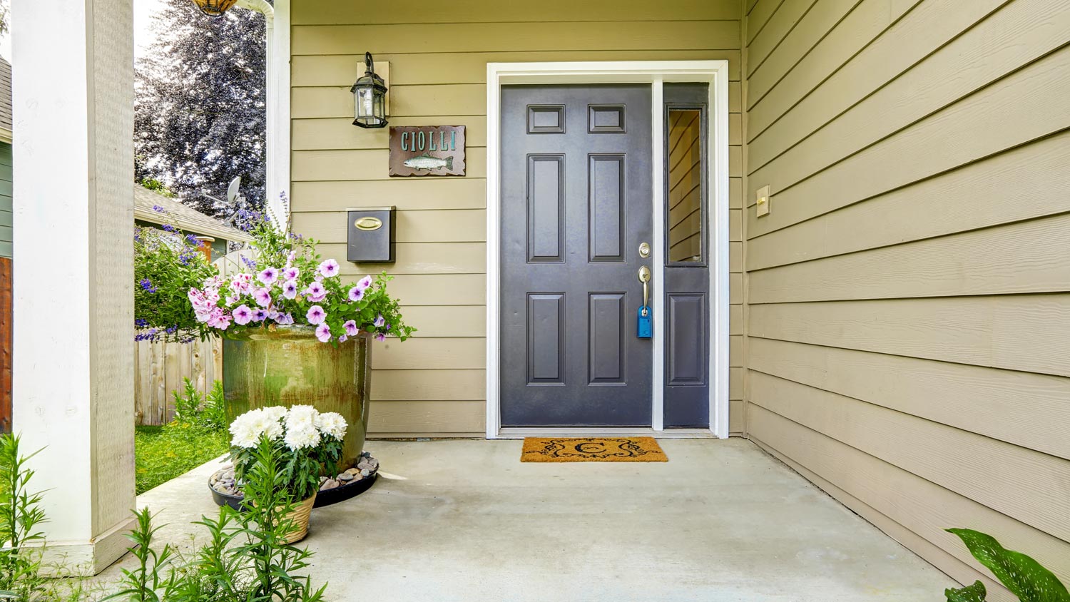 A blue front door on a house with concrete floor