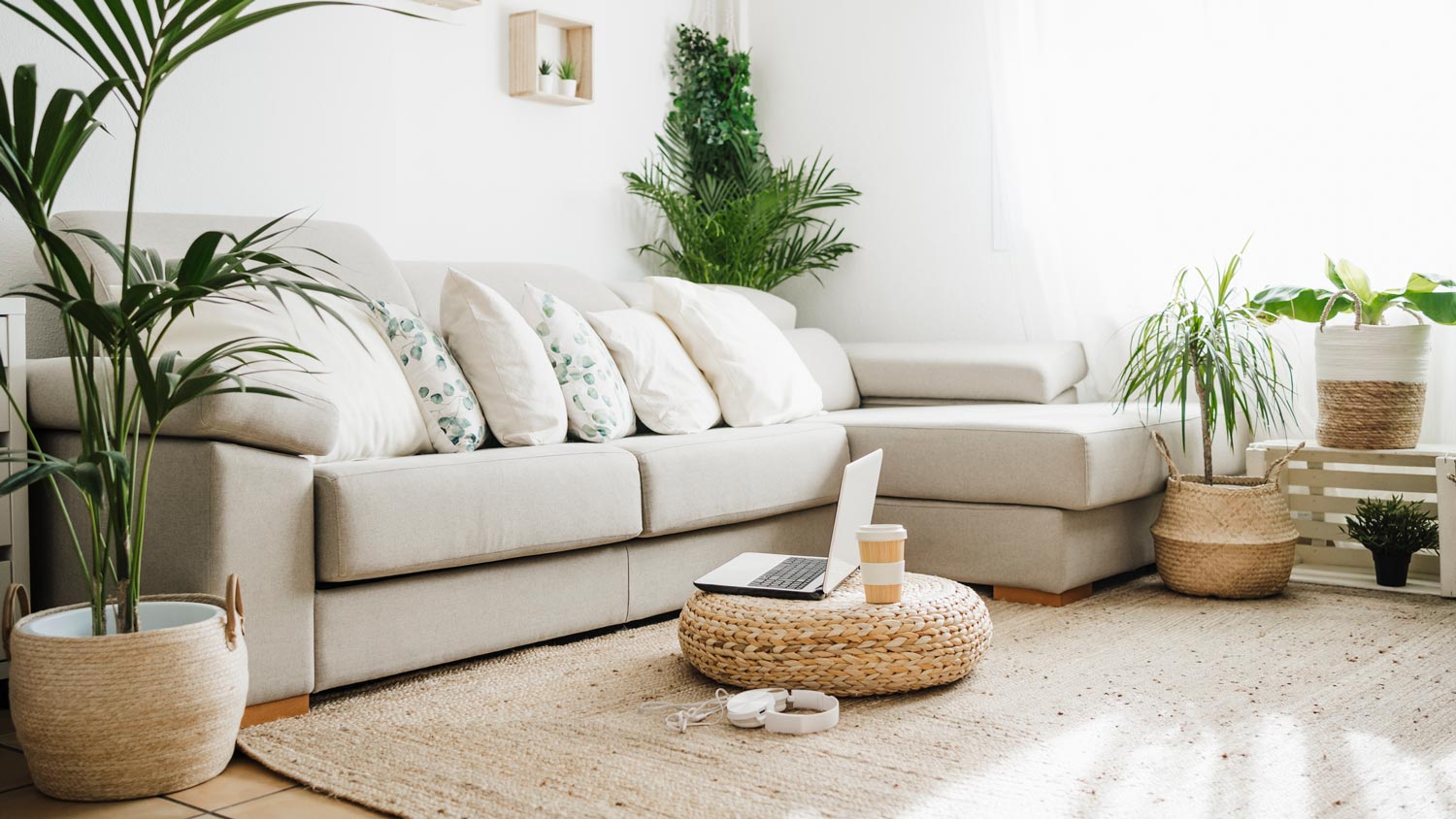 A bright living room with a gray corner sofa