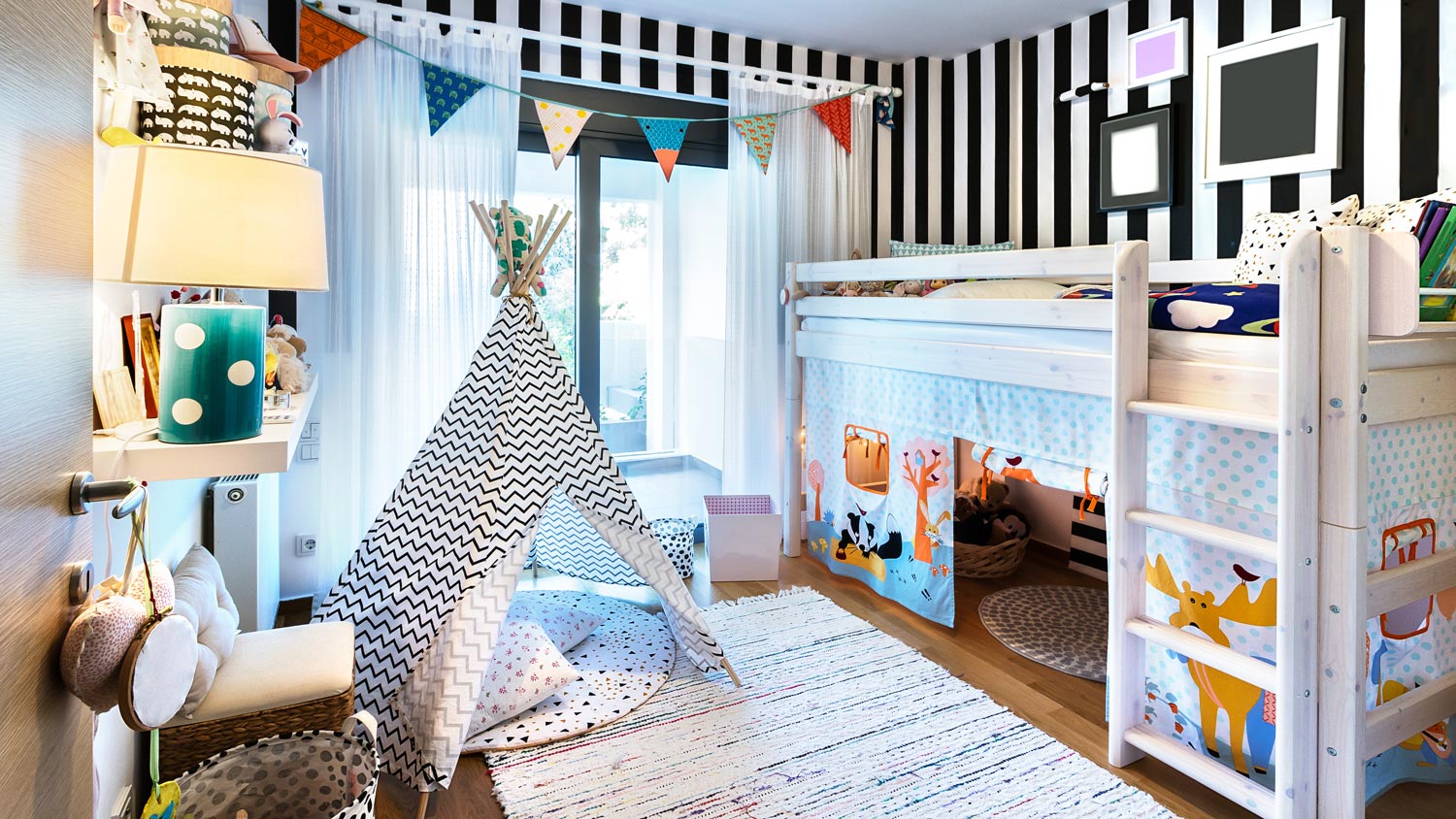 A bunk bed and a teepee in a kids room with patterns on wall