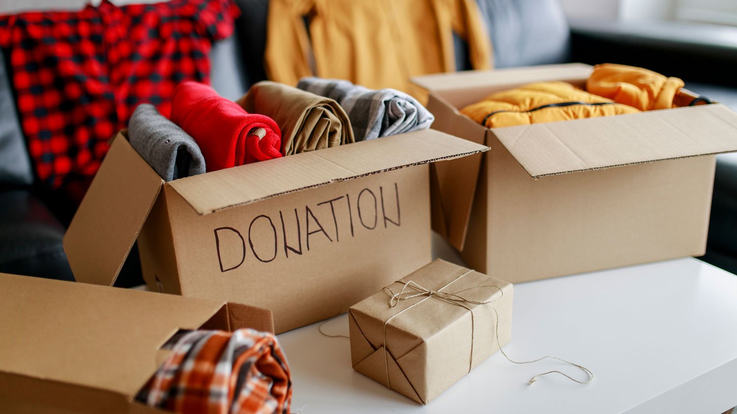 Clothes in donation cardboard boxes