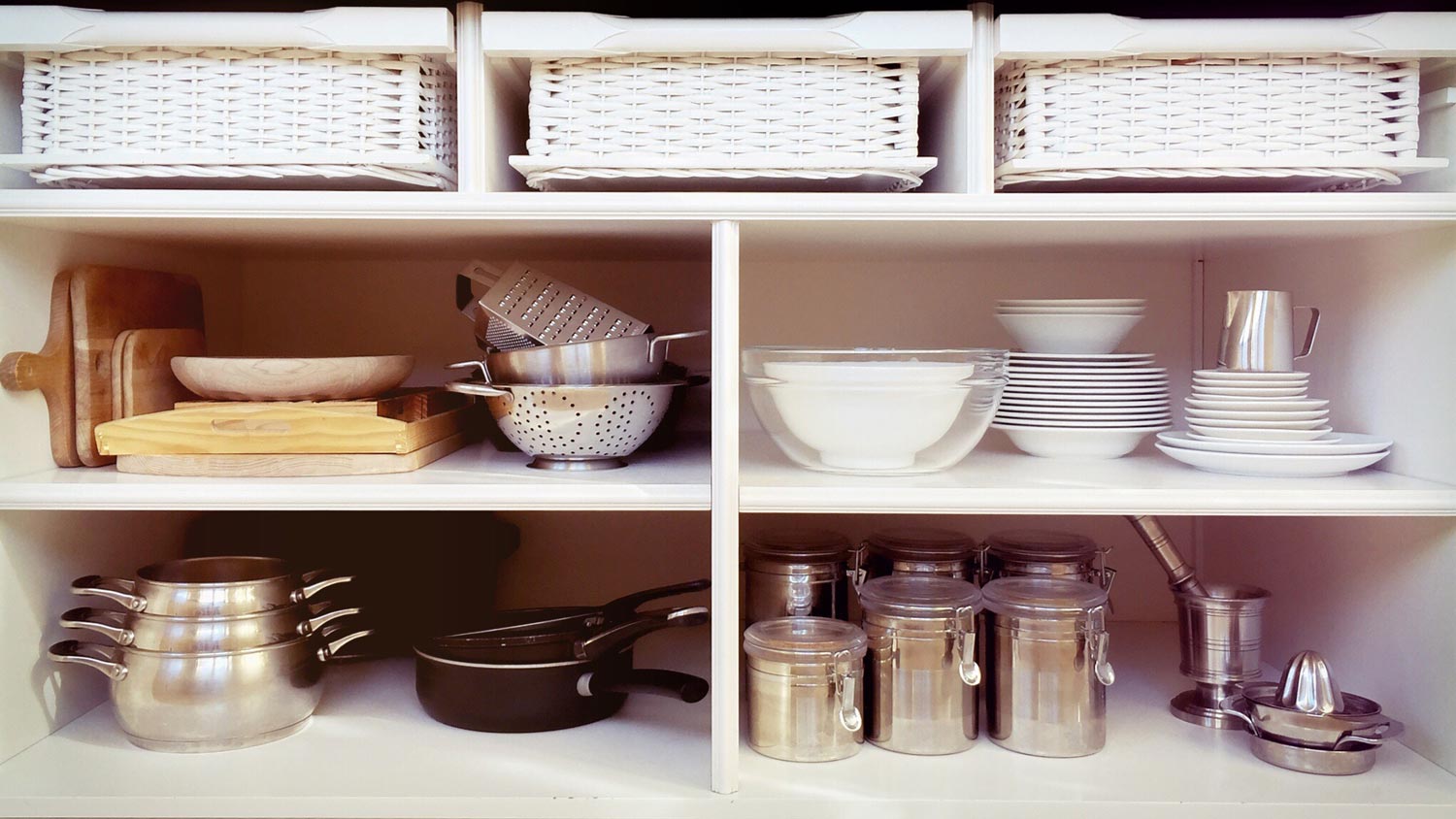 Containers and ceramics arranged beautifully in open shelving