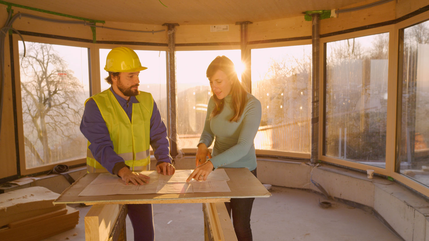 A contractor discussing with homeowner about the blueprints