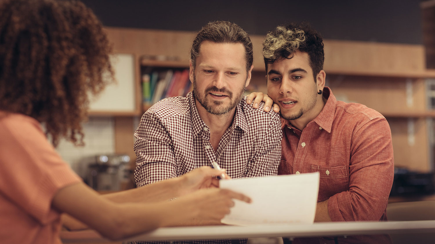 Couple reviewing documents with financial advisor 