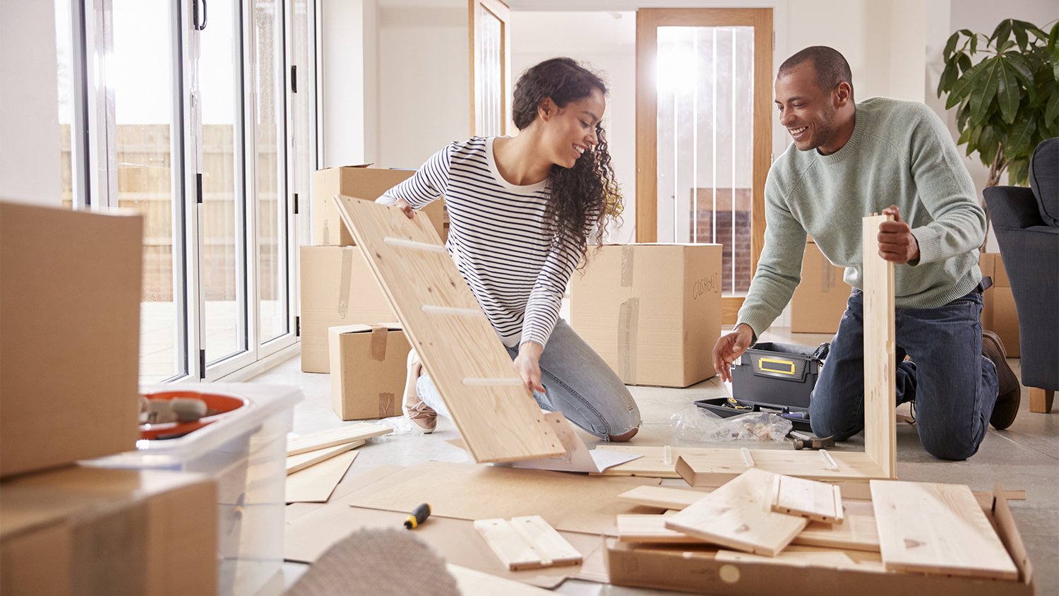 couple assembling furniture in home