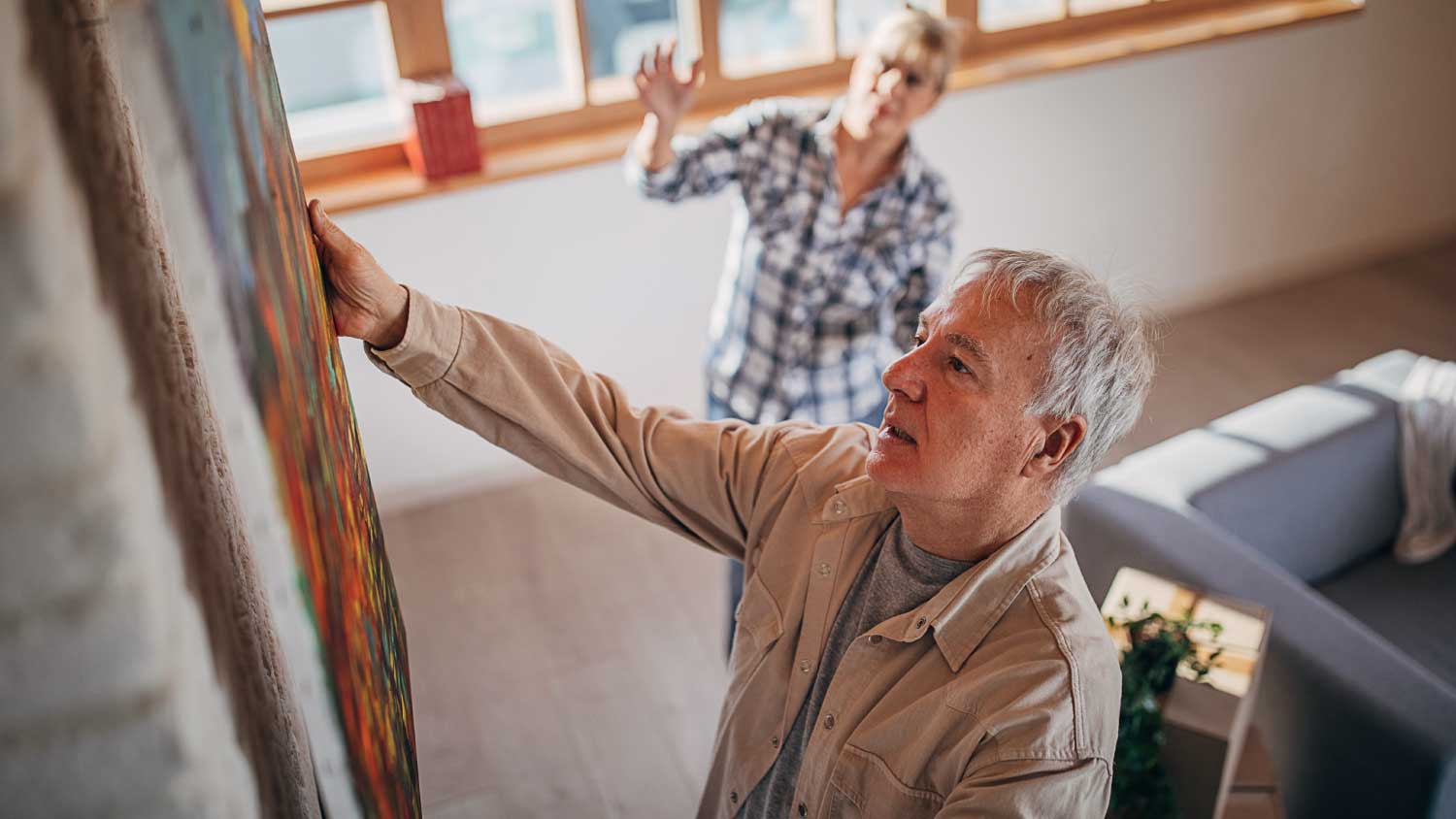 older couple hanging artwork