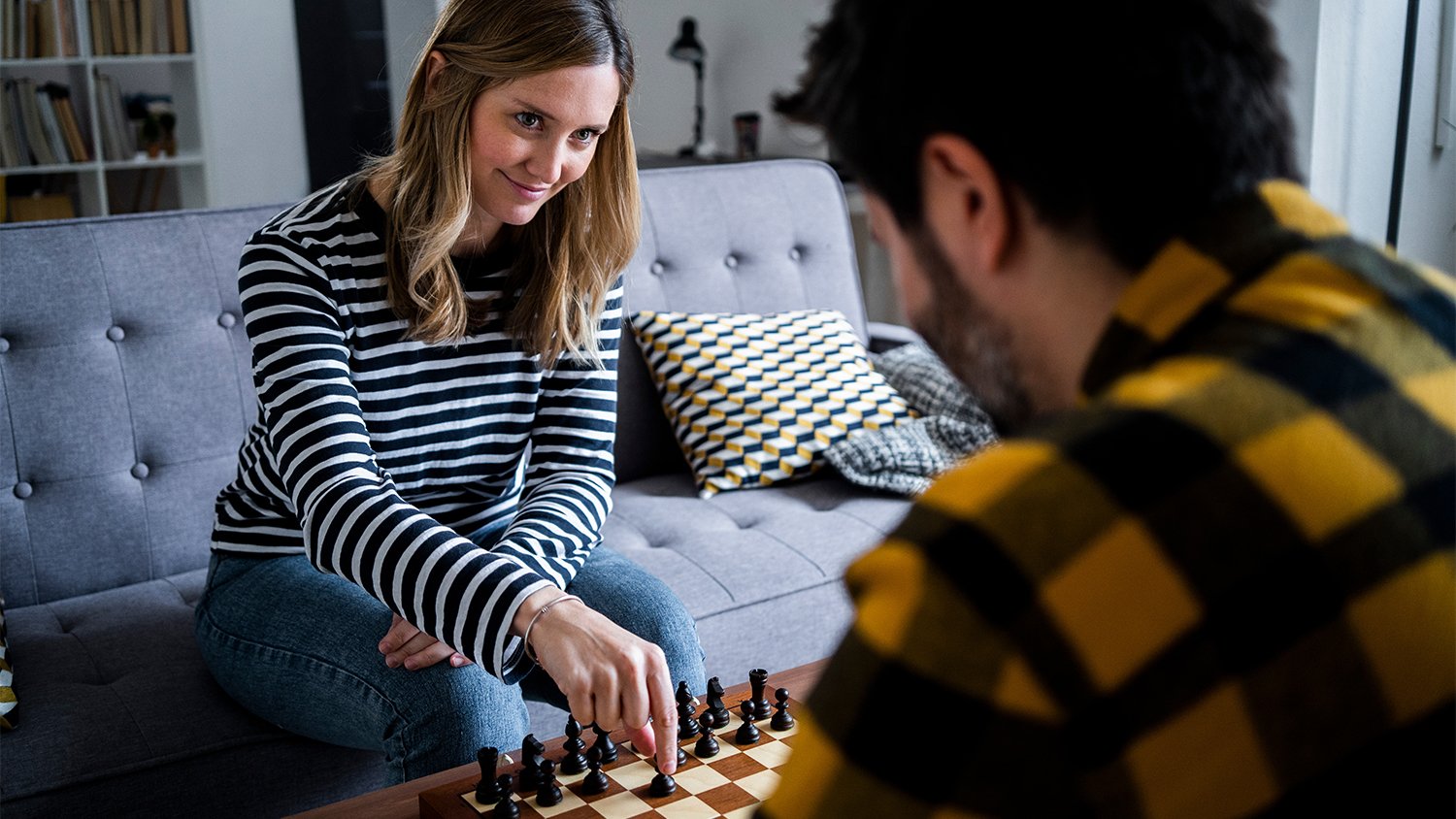 couple playing chess at home