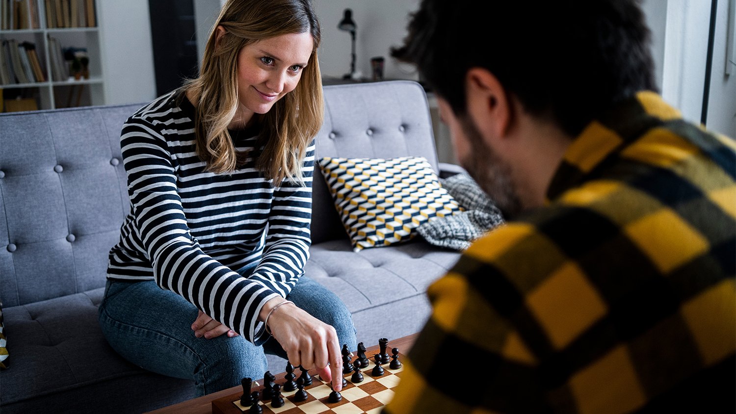 couple playing chess at home    