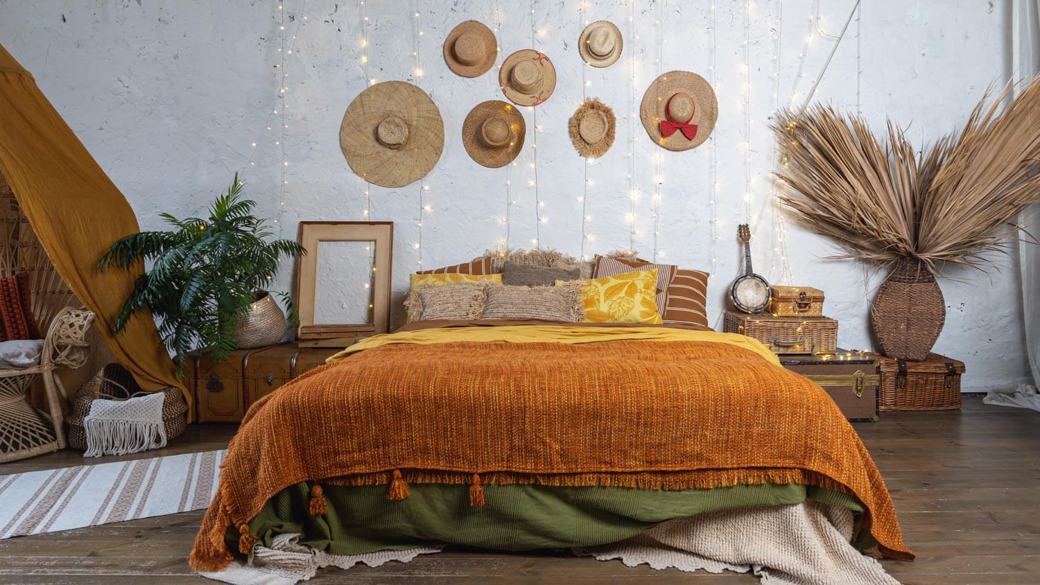 A cozy bedroom in boho style and splashes of orange